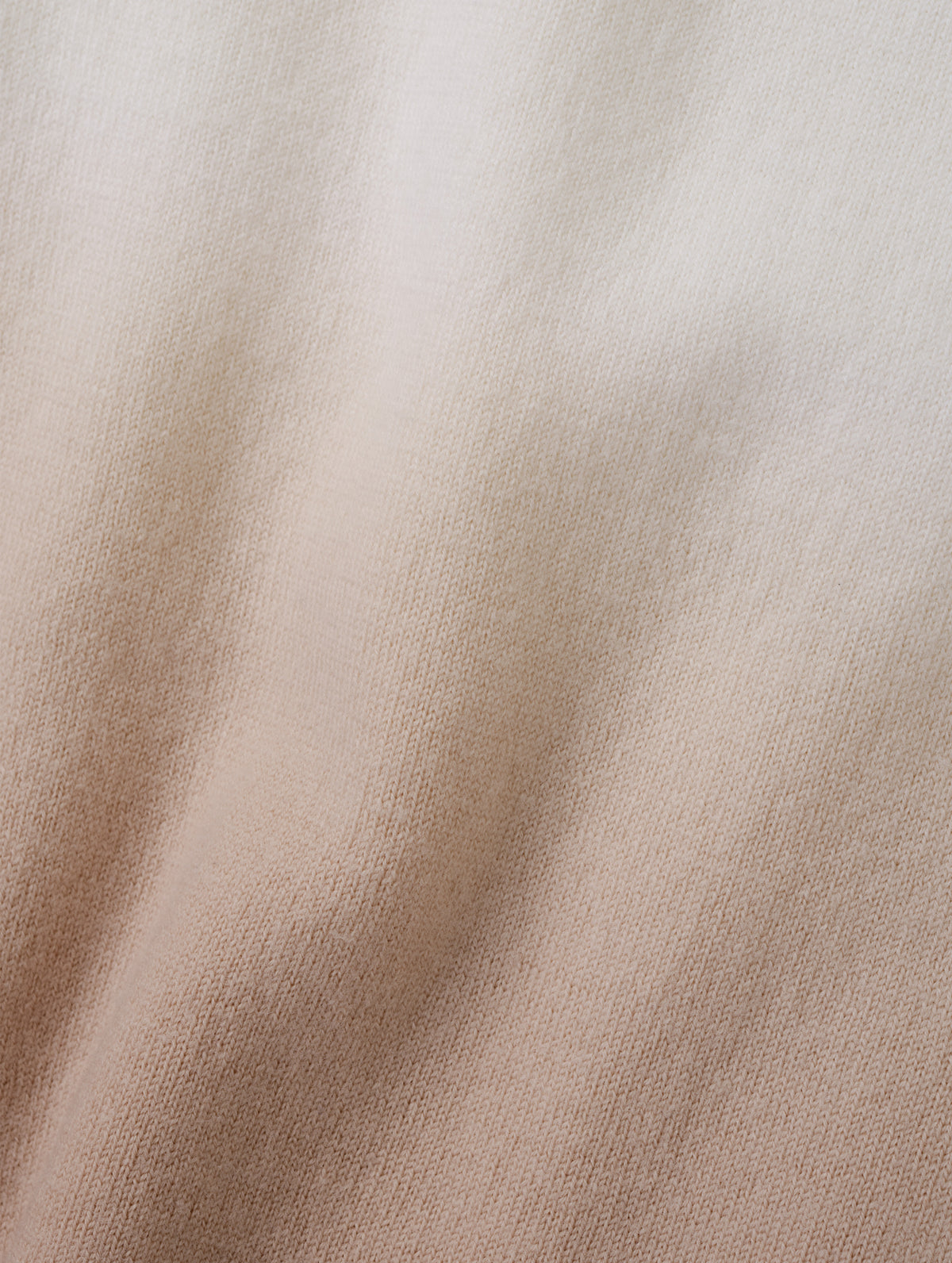 Closeup detailed view of the two-tone dip-dyed colorway on the Dash Ombre Sweater in Winter White from AETHER Apparel.