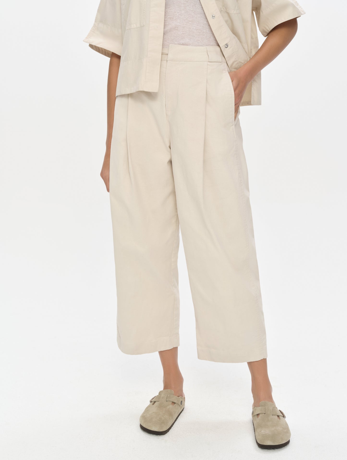 Front, lower-body view of woman wearing the Dune Pant in Bone from AETHER Apparel.