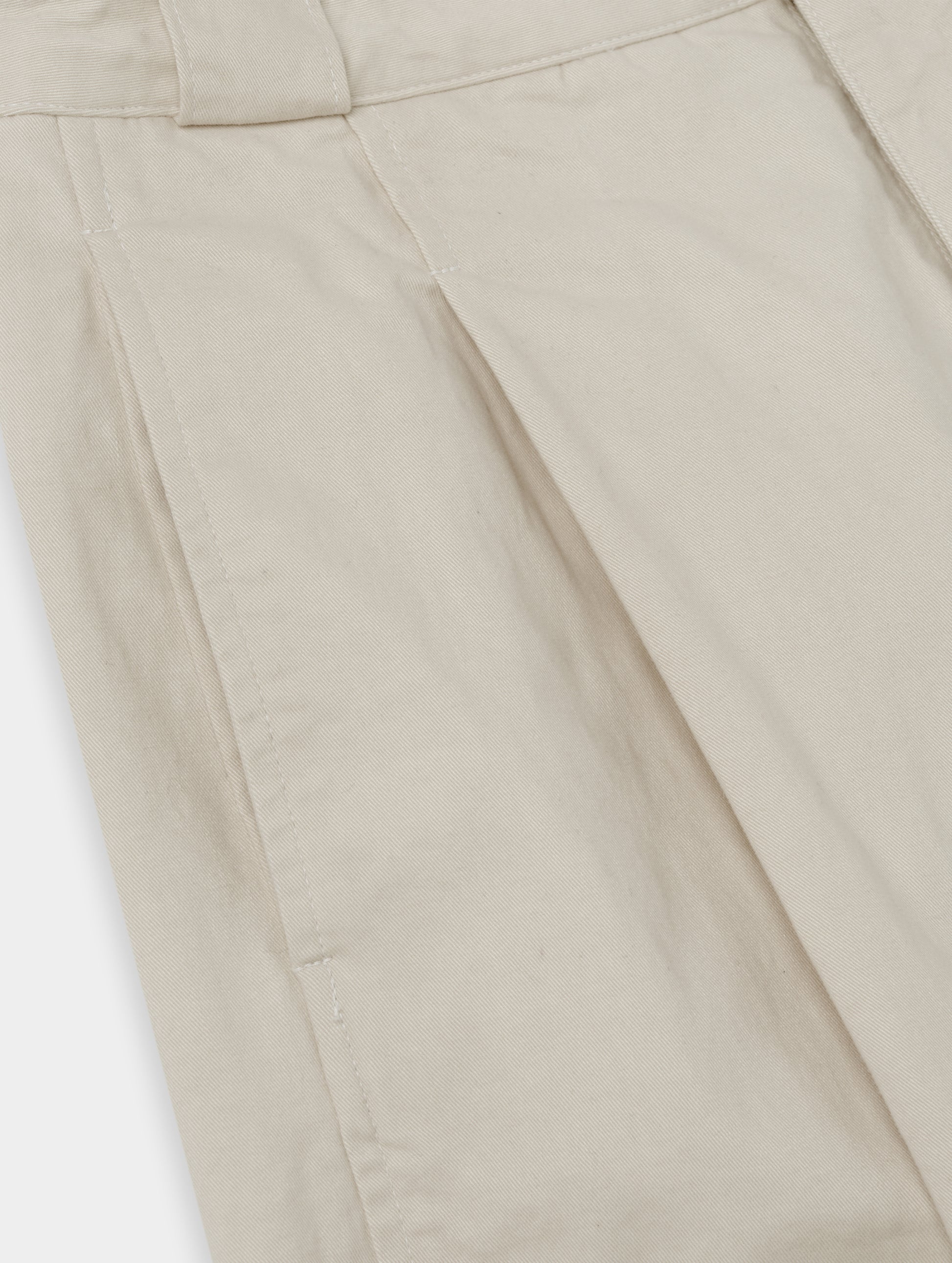 Closeup detailed view of the pleats on the Dune Pant in Bone from AETHER Apparel.