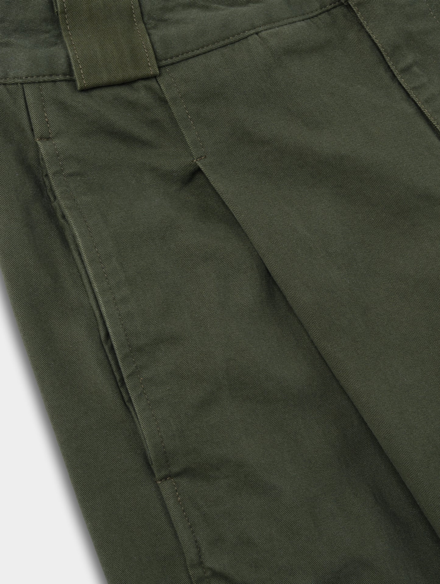 Closeup detailed view of the pleats on the Dune Pant in Forest Green from AETHER Apparel.