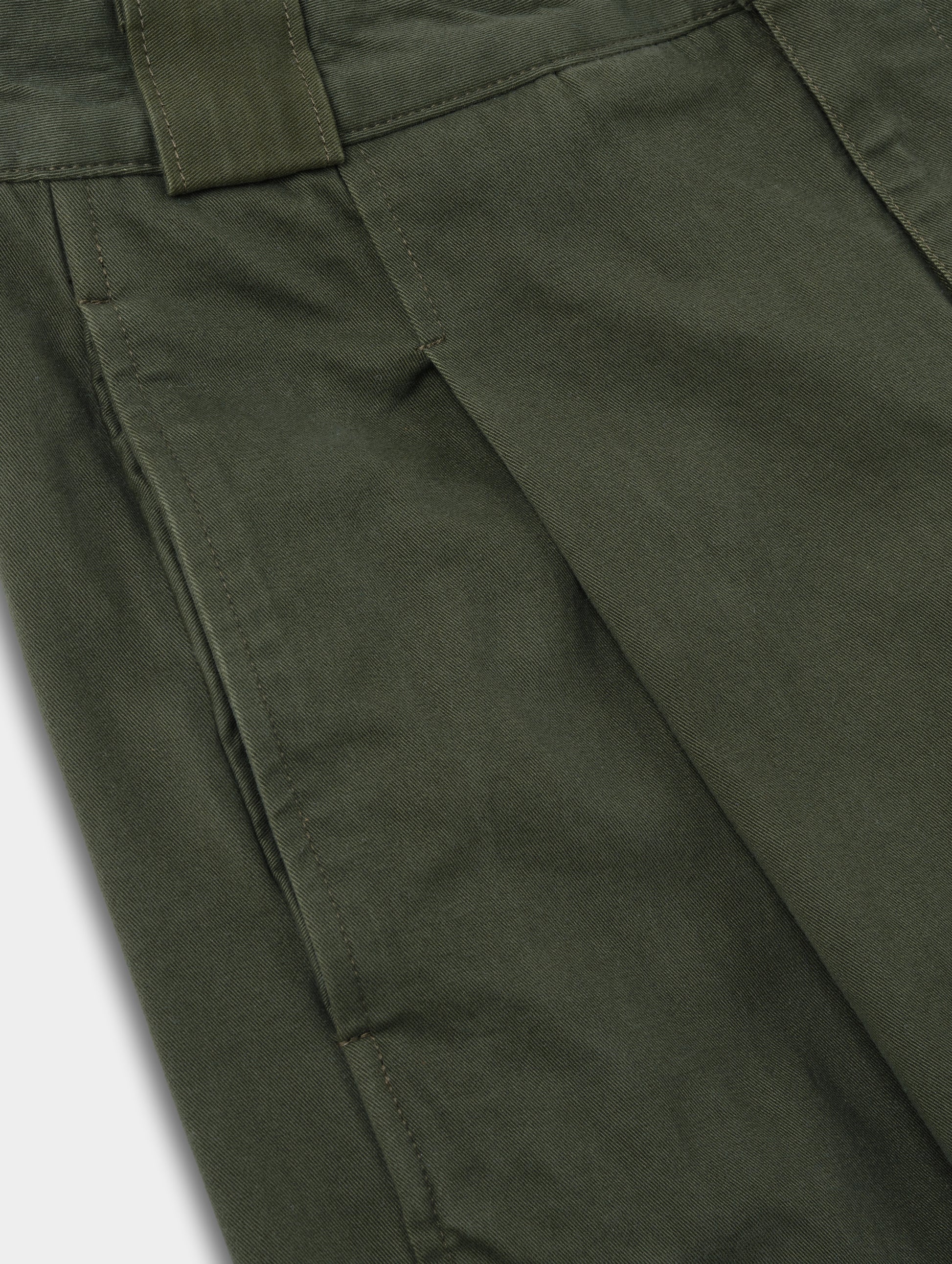 Closeup detailed view of the pleats on the Dune Pant in Forest Green from AETHER Apparel.