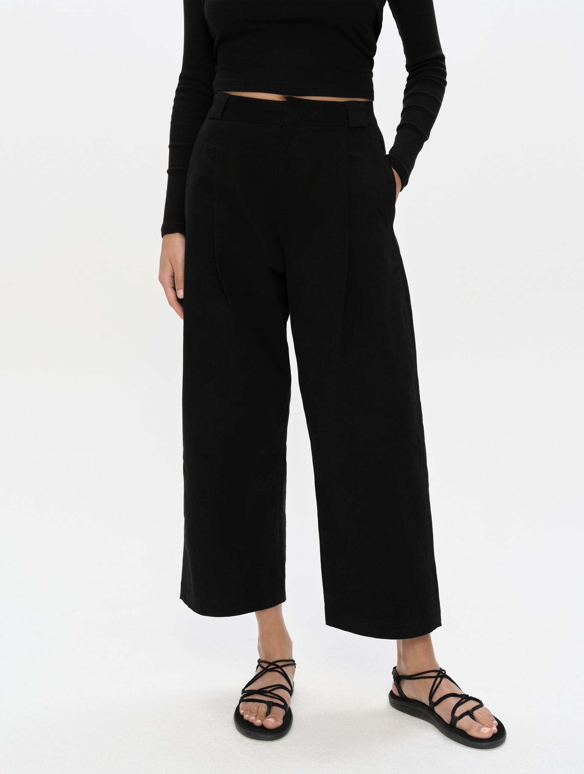 Front, lower-body view of woman wearing the Dune Pant in Onyx Black from AETHER Apparel.