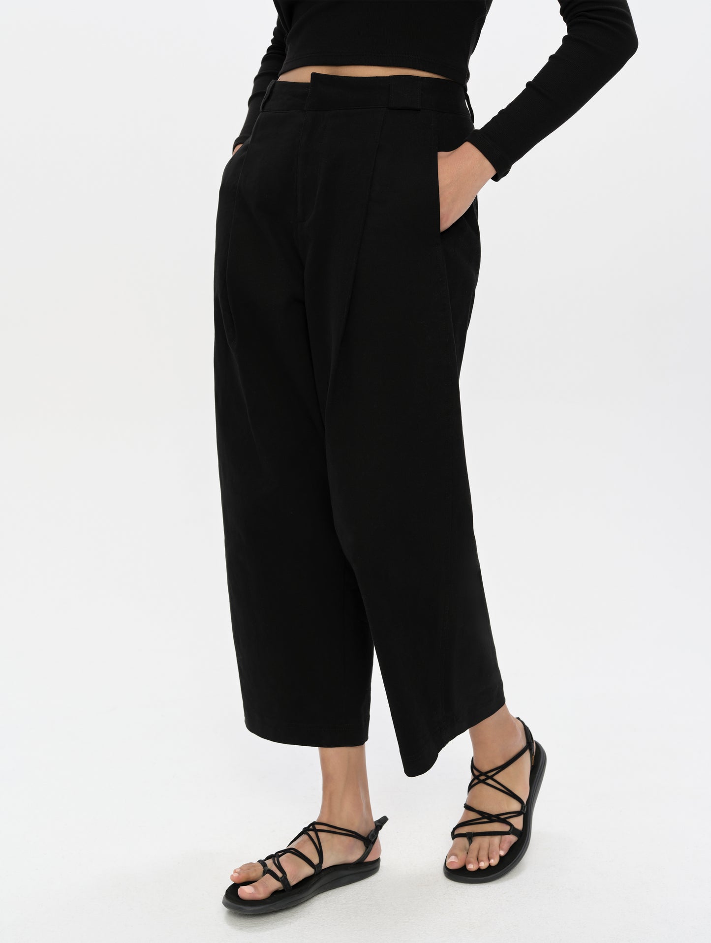 Front, 3/4, lower-body view of woman wearing the Dune Pant in Onyx Black from AETHER Apparel.