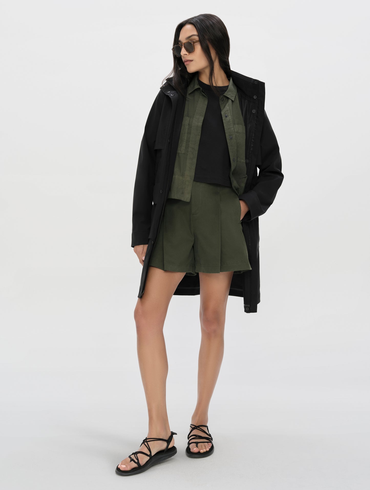 Front, full-body view of woman wearing the Dune Short in Forest Green from AETHER Apparel.