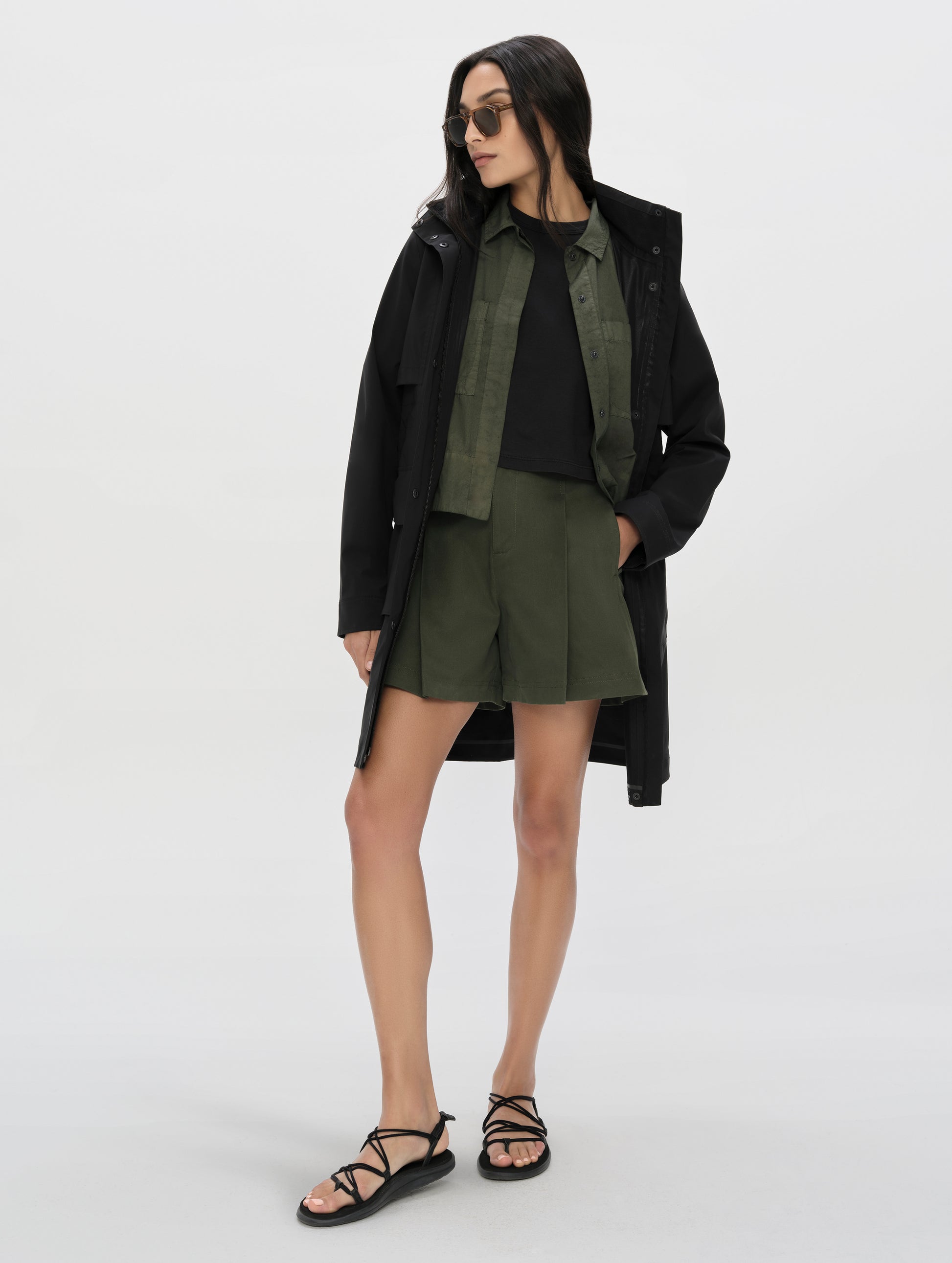 Front, full-body view of woman wearing the Dune Short in Forest Green from AETHER Apparel.