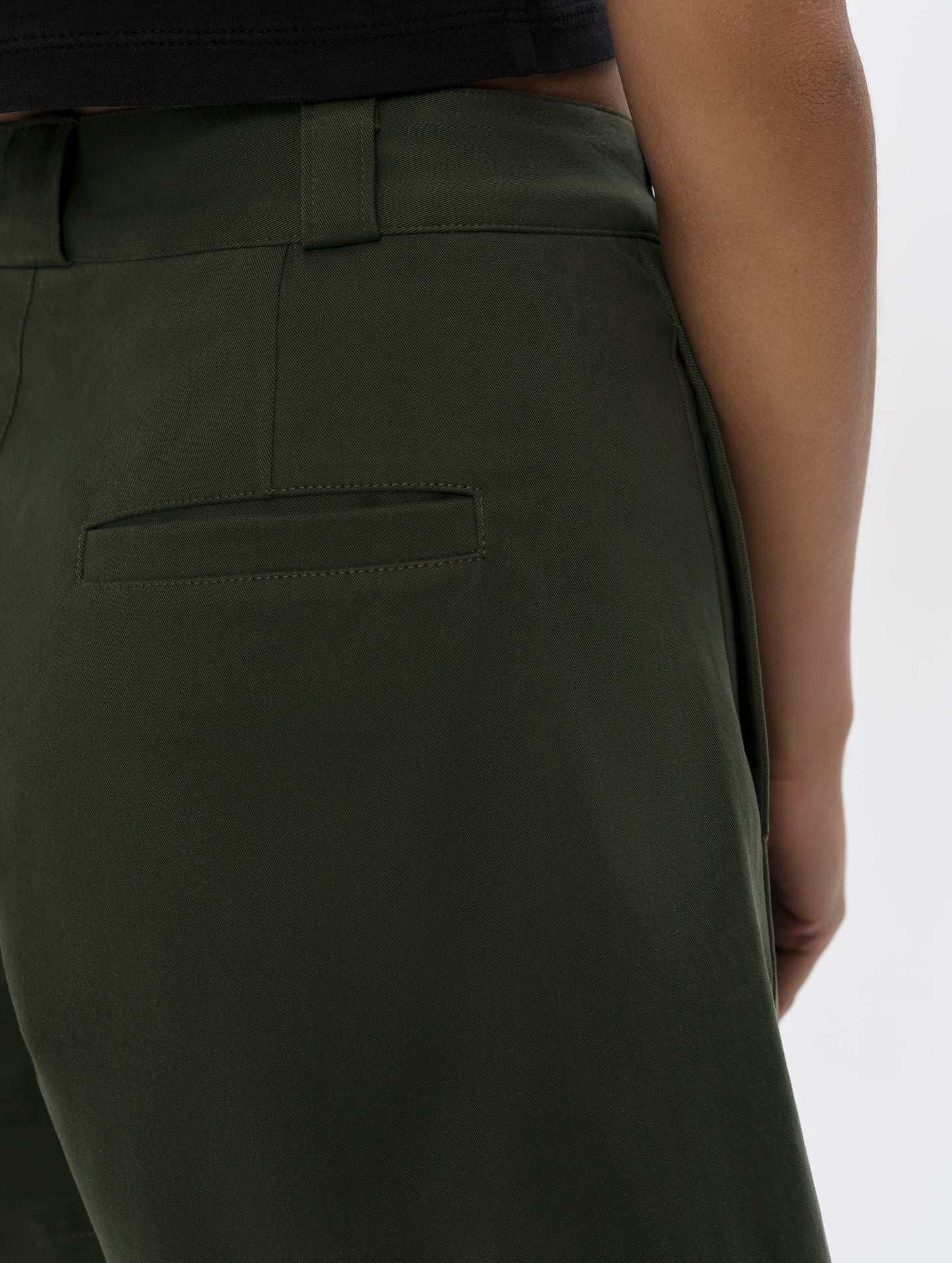 Closeup detailed view of the rear pockets on the Dune Short in Forest Green from AETHER Apparel.