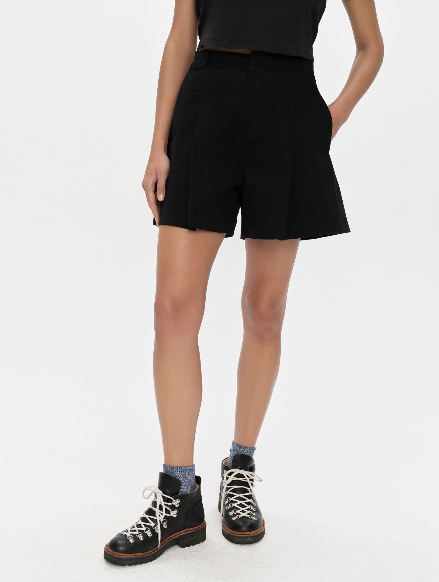 Front, lower-body view of woman wearing the Dune Short in Onyx Black from AETHER Apparel.