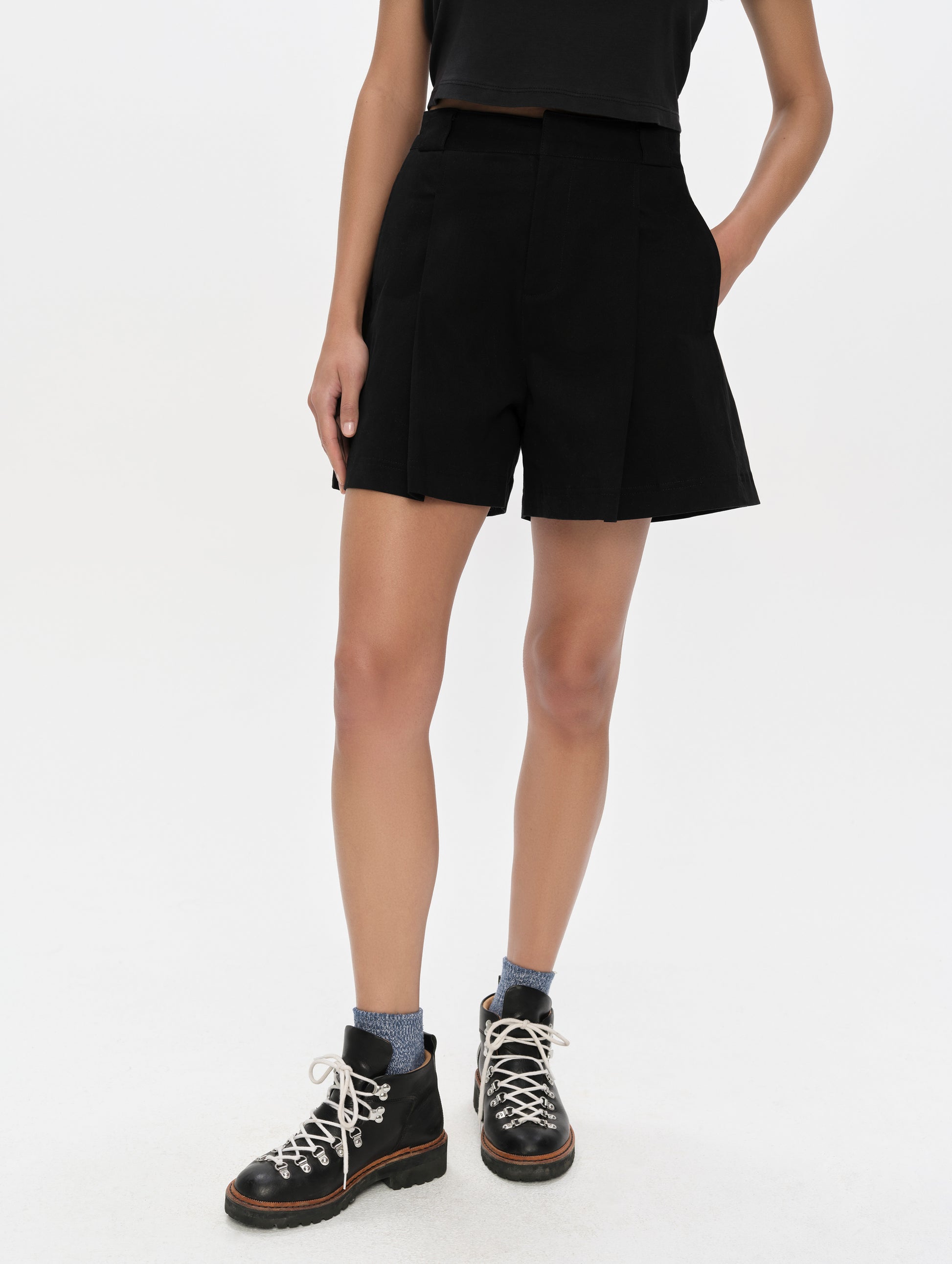Front, lower-body view of woman wearing the Dune Short in Onyx Black from AETHER Apparel.