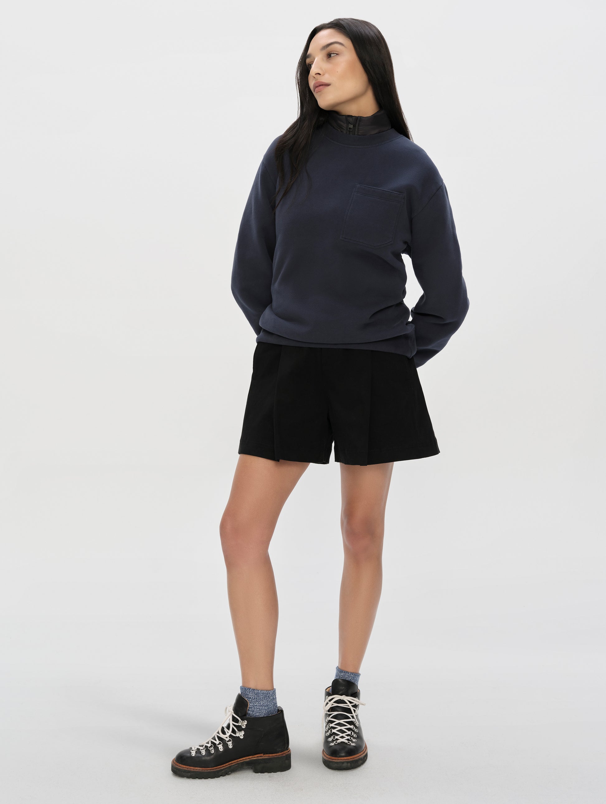Front, full-body view of woman wearing the Dune Short in Onyx Black from AETHER Apparel.