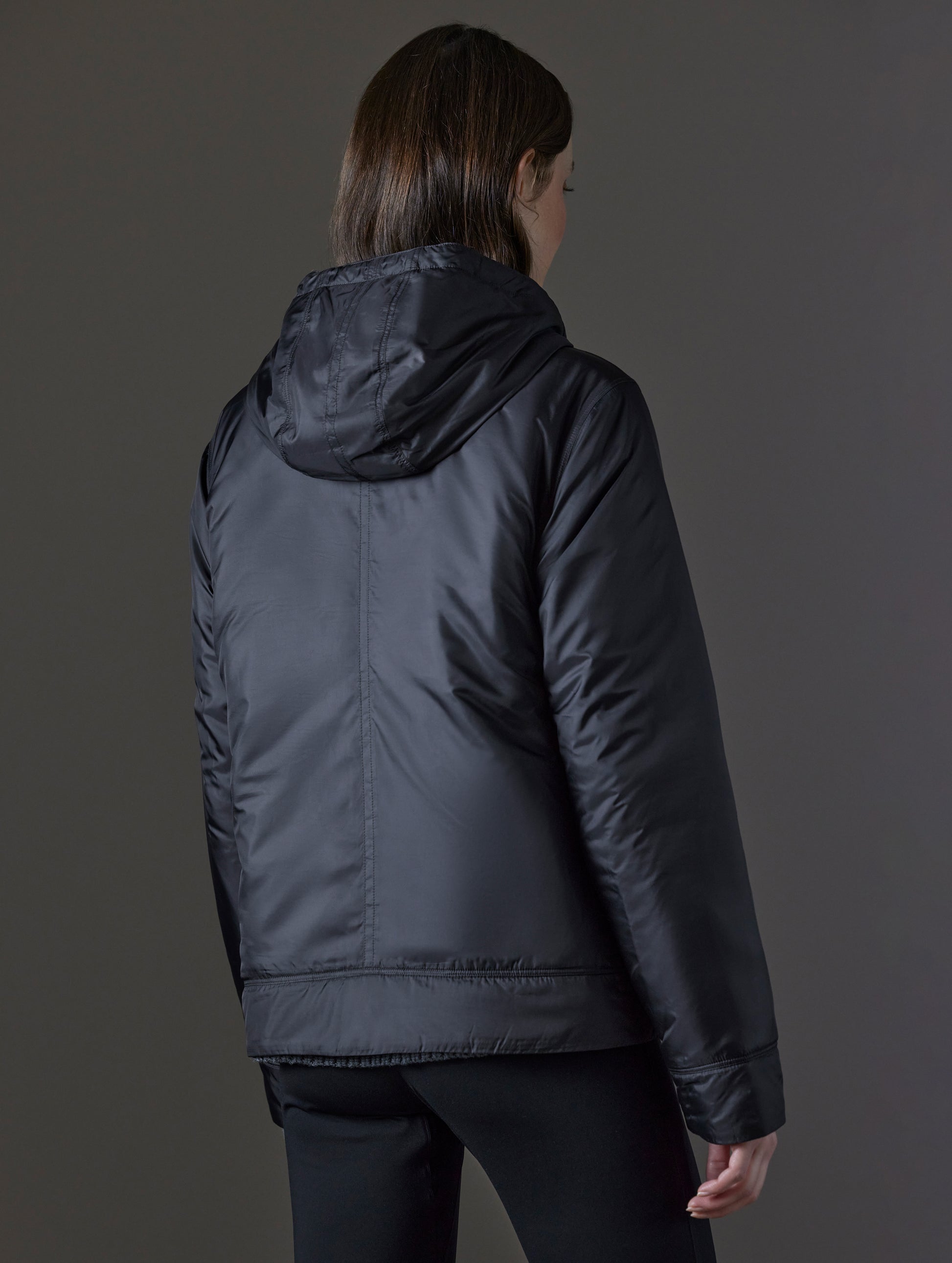 Woman wearing black insulated jacket from AETHER Apparel