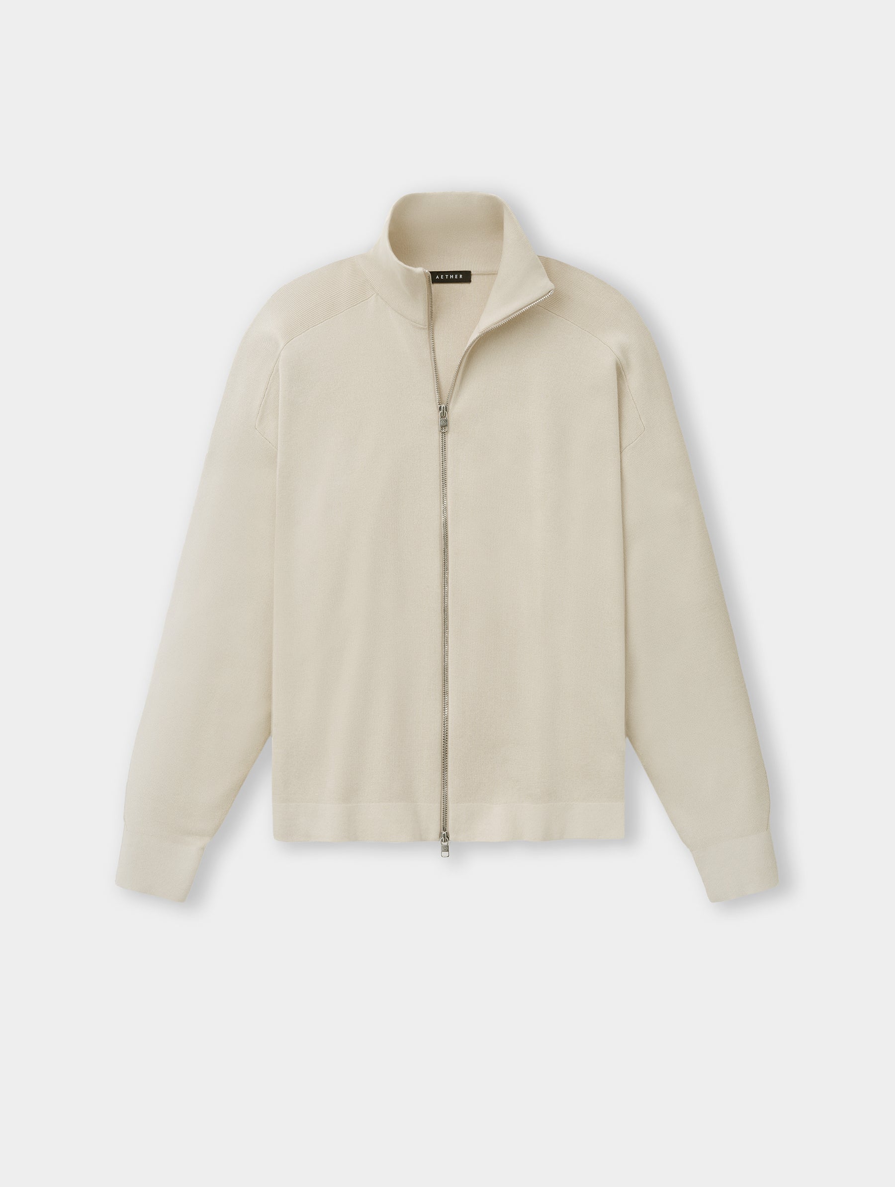 Flat lay view of the Eliana Full-ZIp Sweater in Bone from AETHER.