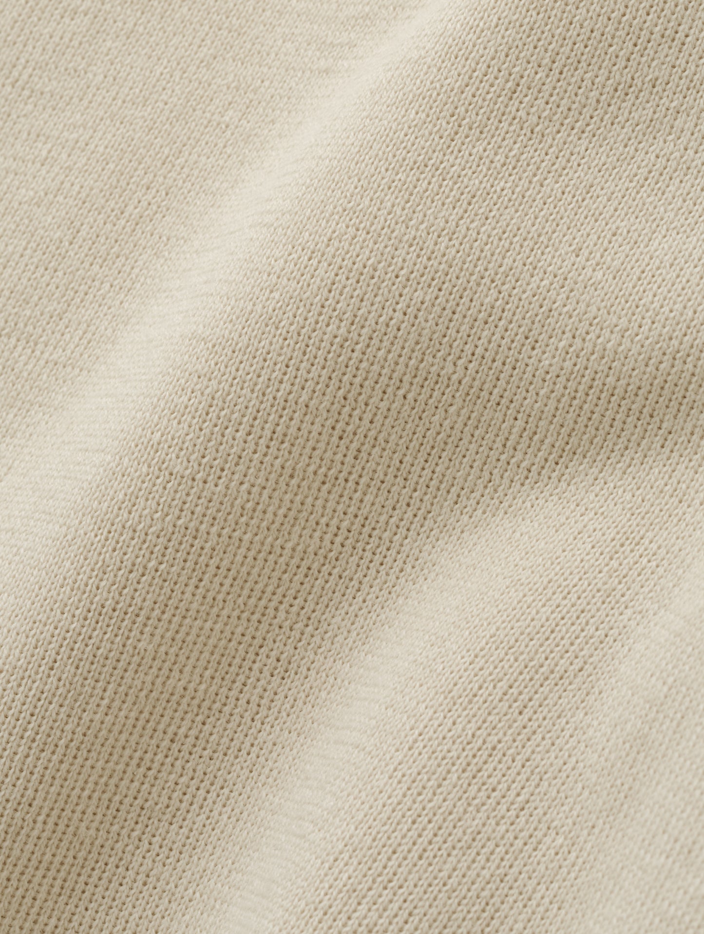 Closeup detailed view of the fabric on the Eliana Full-ZIp Sweater in Bone from AETHER Apparel.