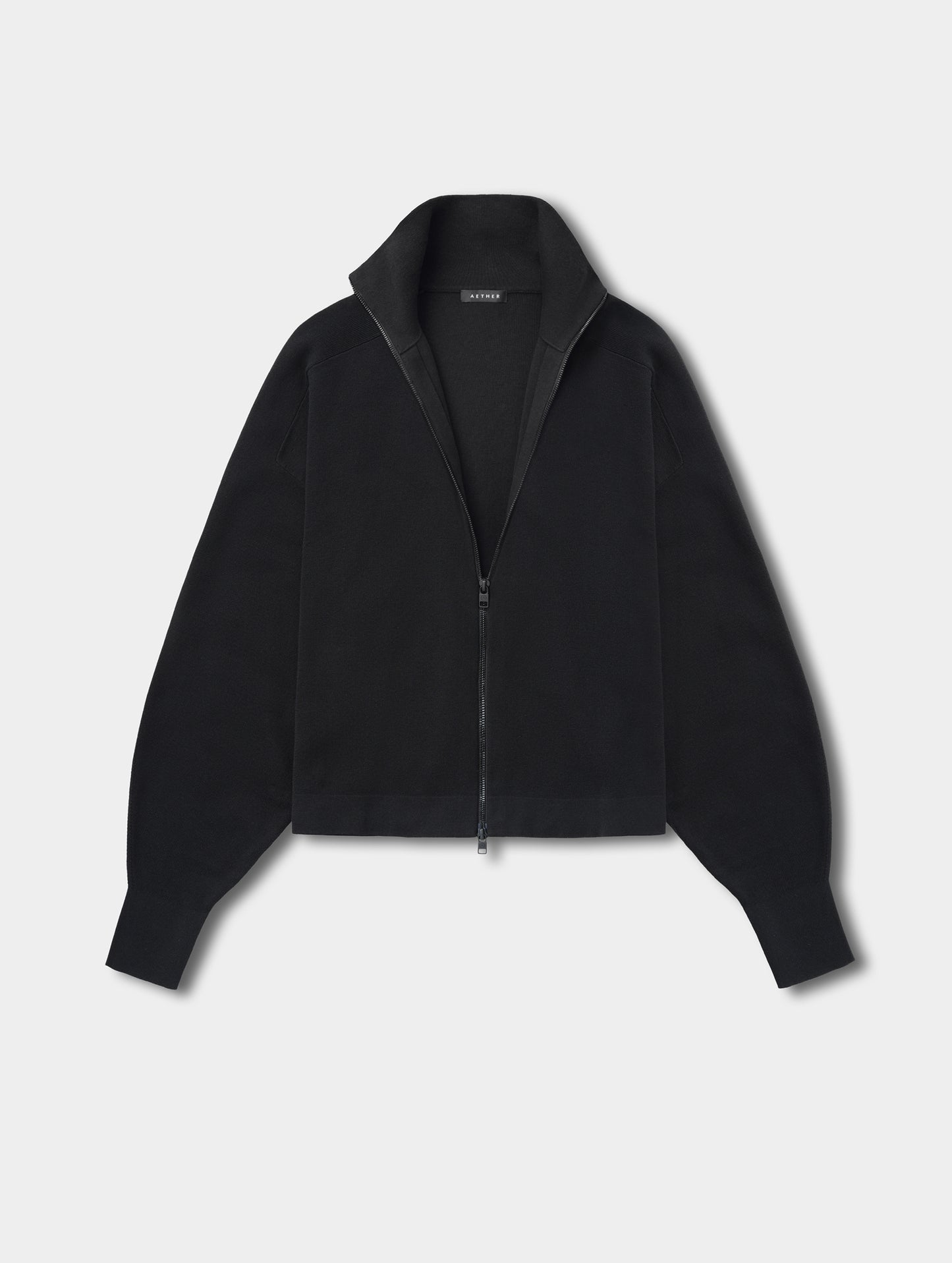 Flat lay view of the Eliana Full-ZIp Sweater in Onyx Black from AETHER.