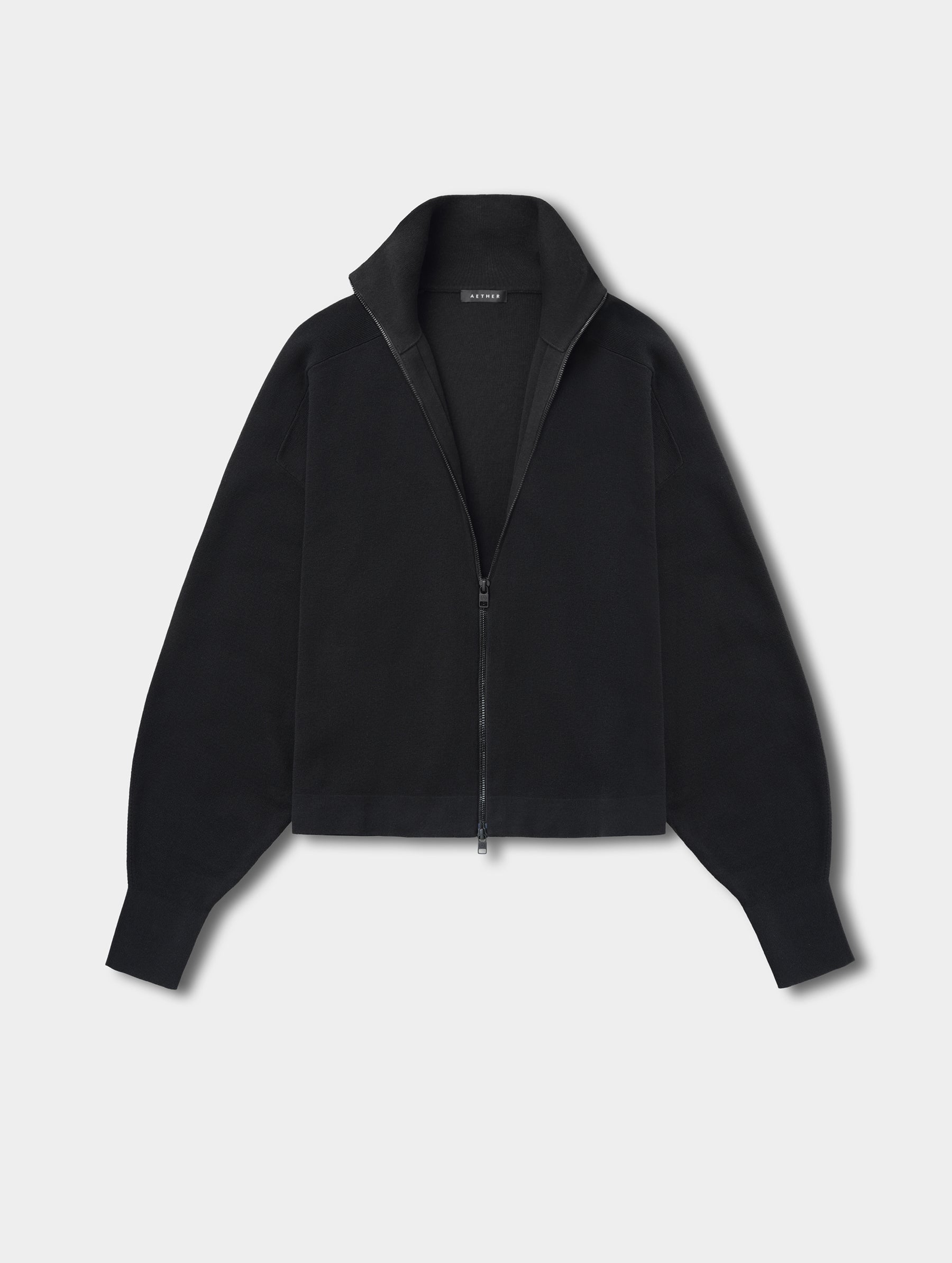 Flat lay view of the Eliana Full-ZIp Sweater in Onyx Black from AETHER.