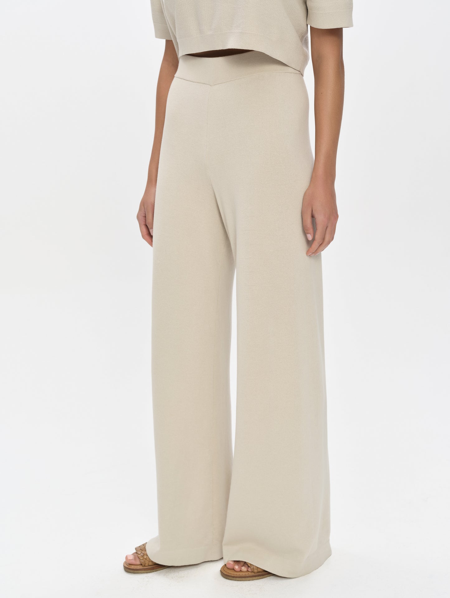 Front, 3/4, lower-body view of woman wearing the Eliana Sweater Pant in Bone from AETHER Apparel.