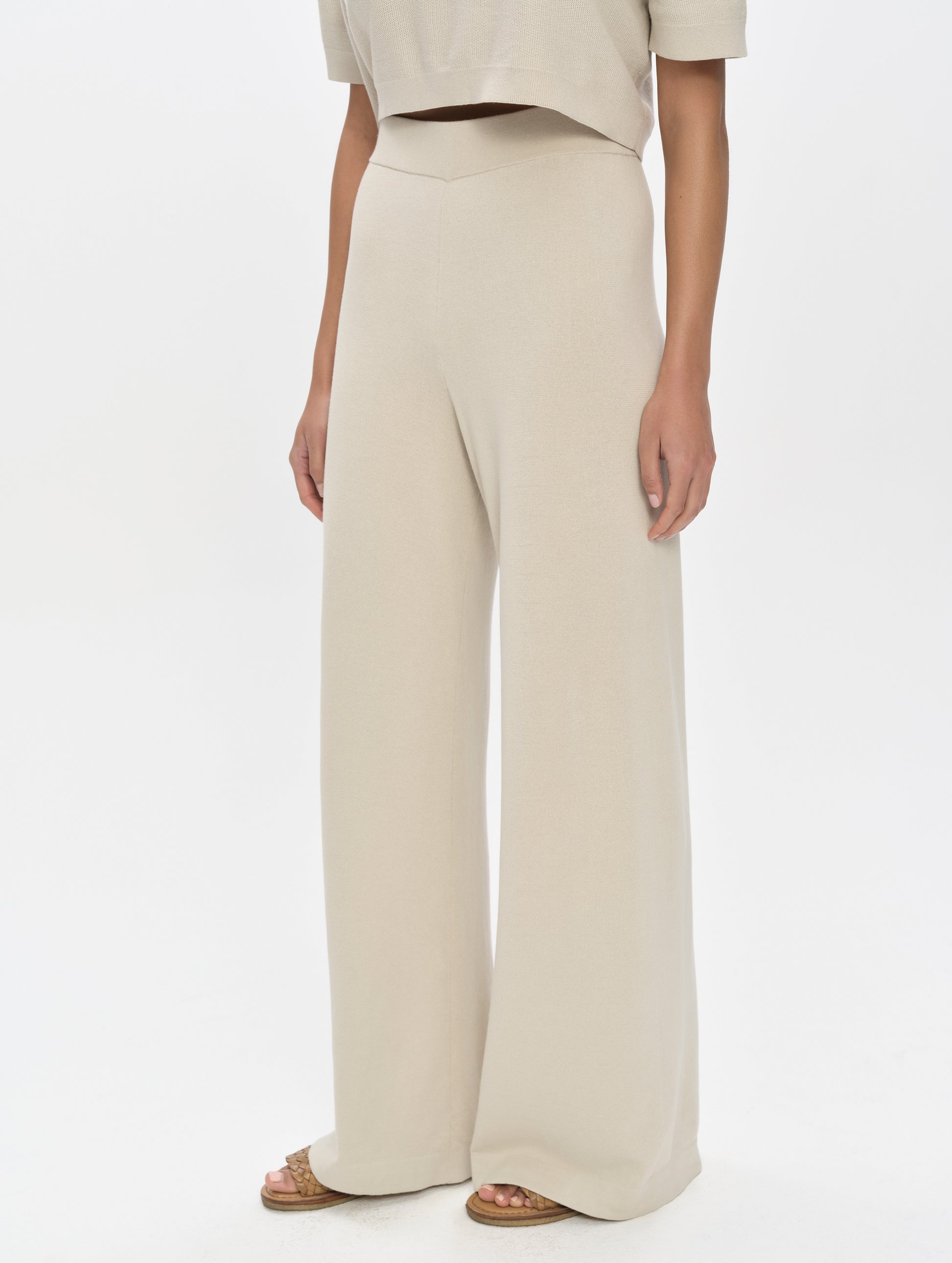 Front, 3/4, lower-body view of woman wearing the Eliana Sweater Pant in Bone from AETHER Apparel.