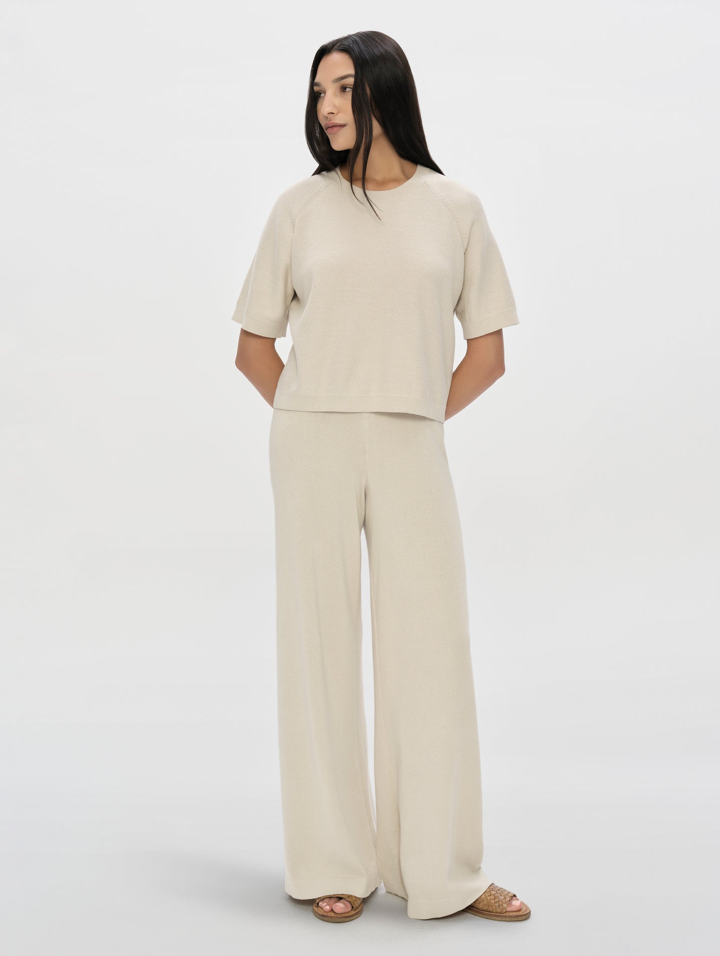 Front, full-body view of woman wearing the Eliana Sweater Pant in Bone from AETHER Apparel.