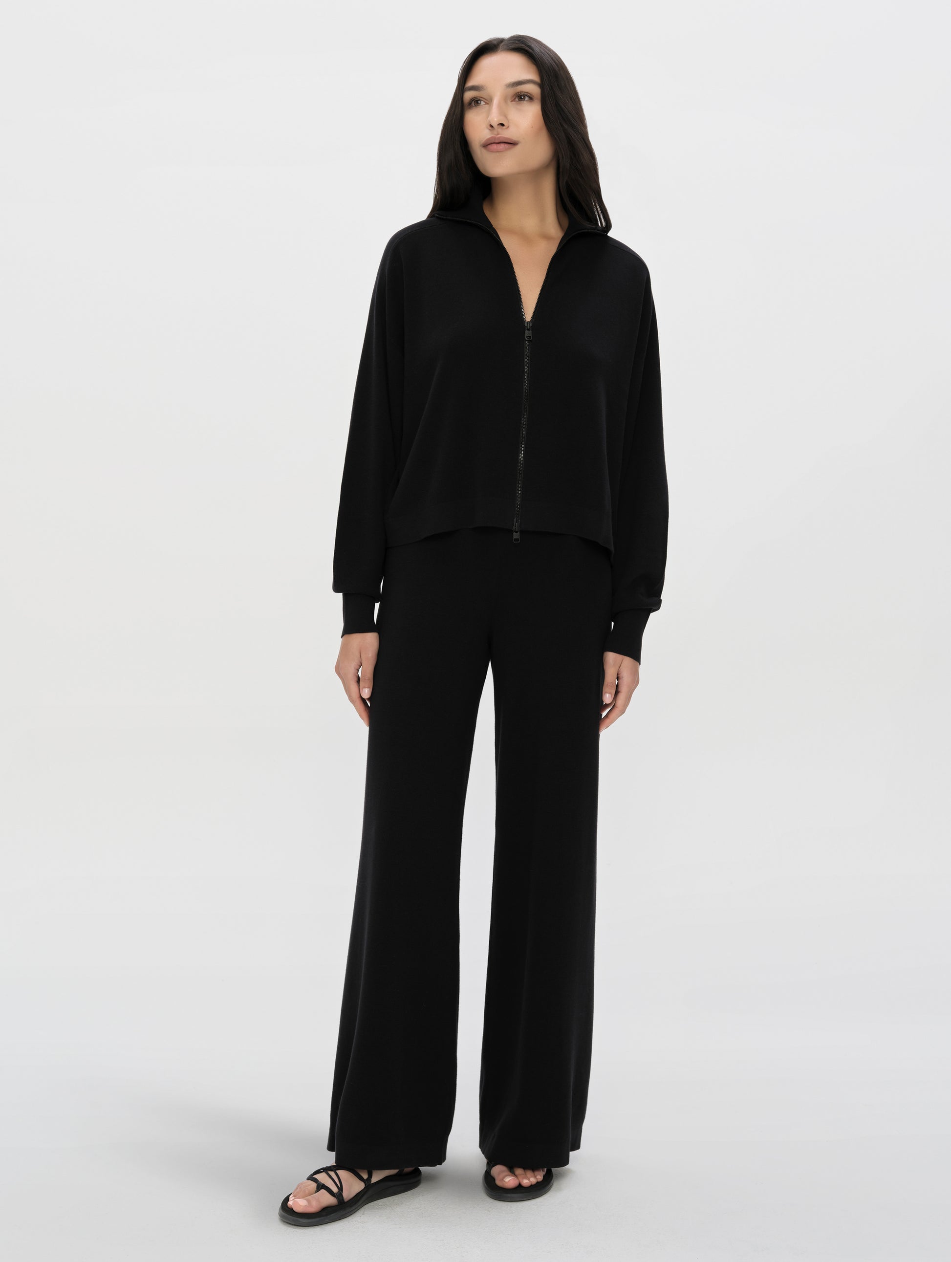 Front, full-body view of woman wearing the Eliana Sweater Pant in Onyx Black from AETHER Apparel.