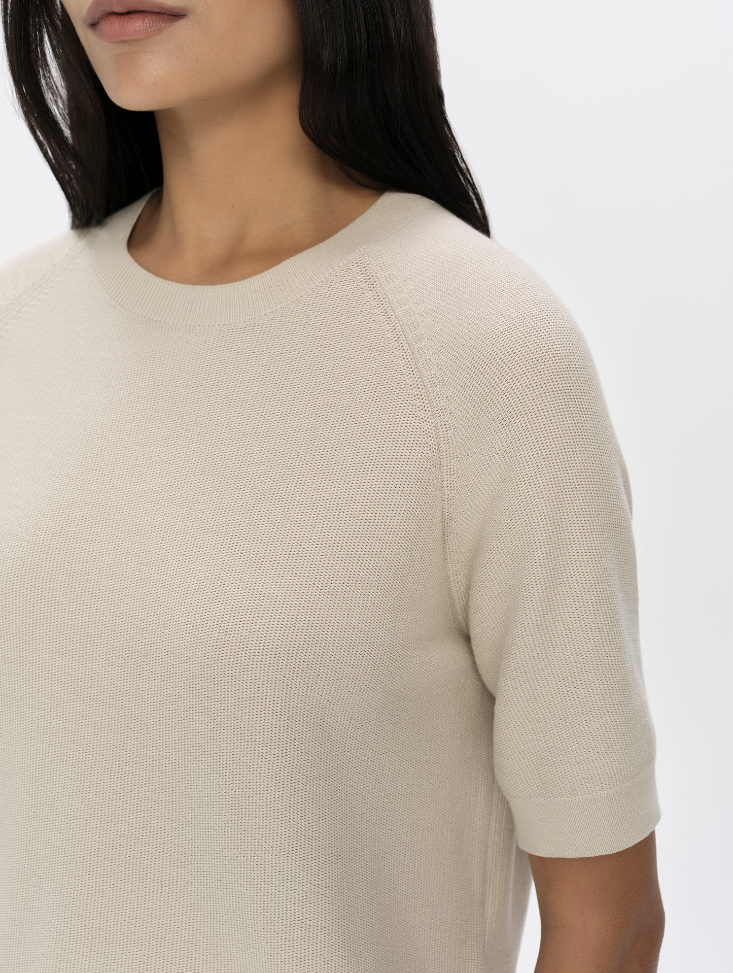 Closeup detailed view of the shoulder, collar, and sleeve hem on the Eliana Sweater Tee in Bone from AETHER Apparel.