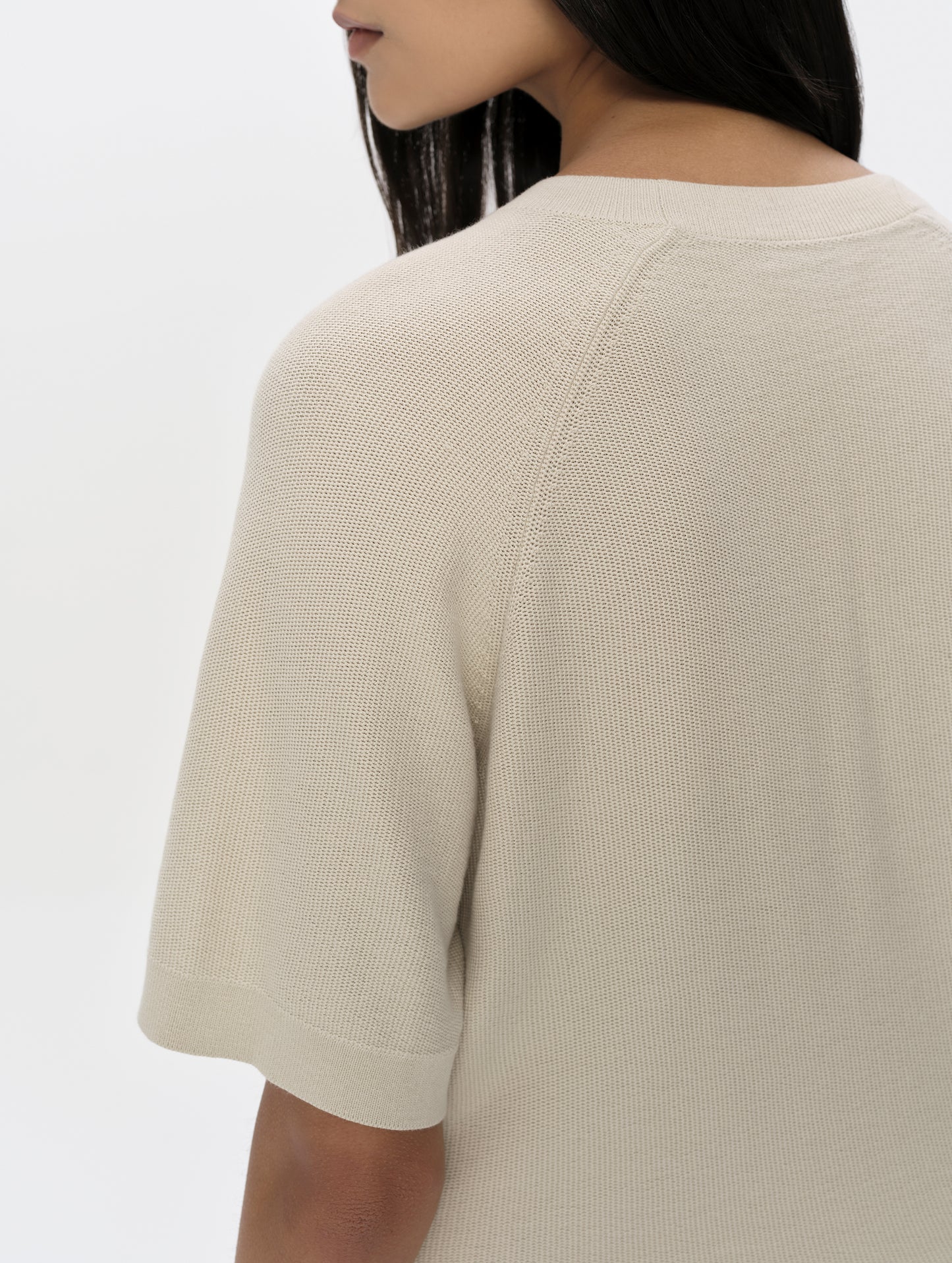 Closeup detailed view of the shoulder and sleeve hem on the Eliana Sweater Tee in Bone from AETHER Apparel.