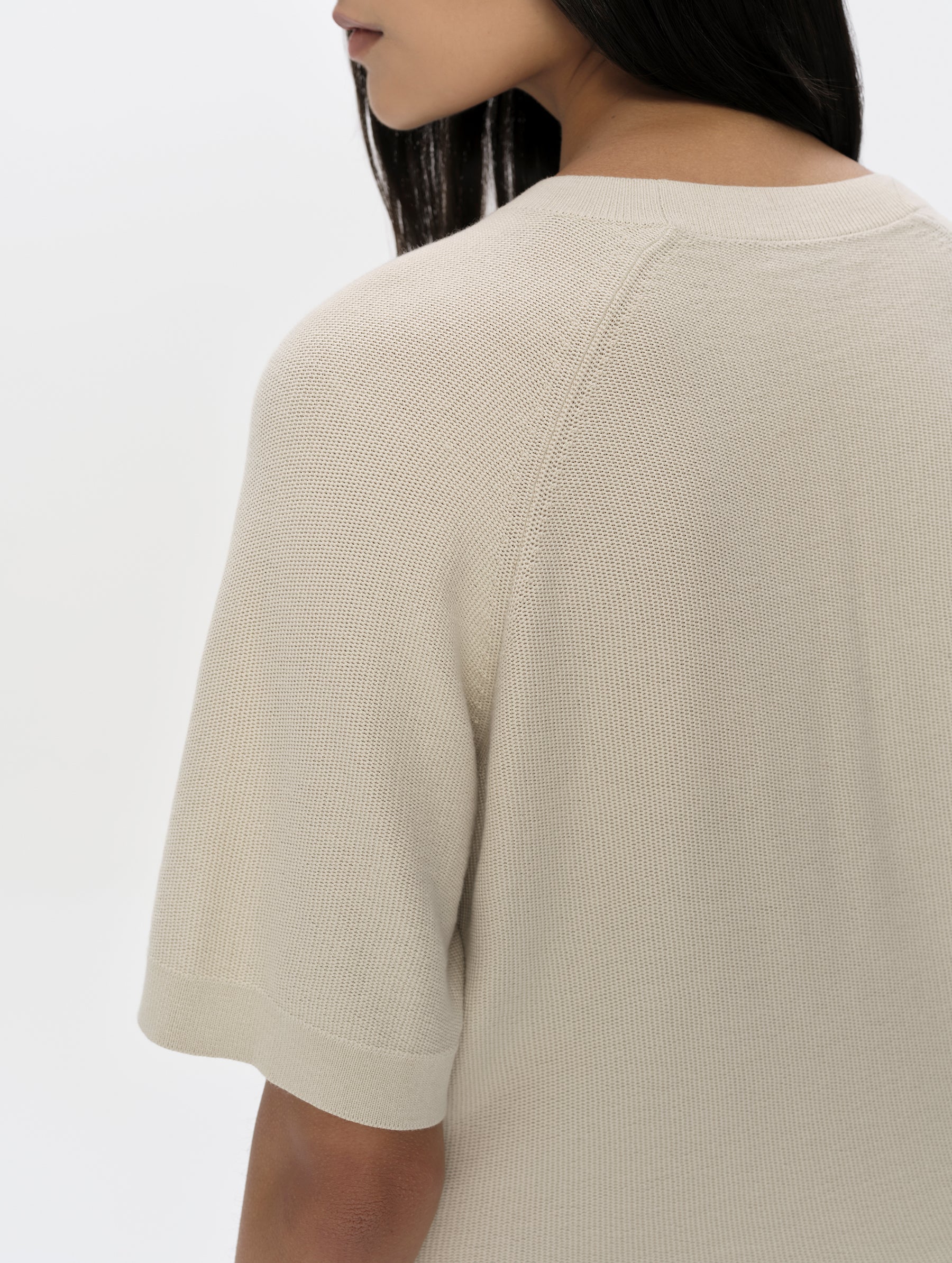 Closeup detailed view of the shoulder and sleeve hem on the Eliana Sweater Tee in Bone from AETHER Apparel.