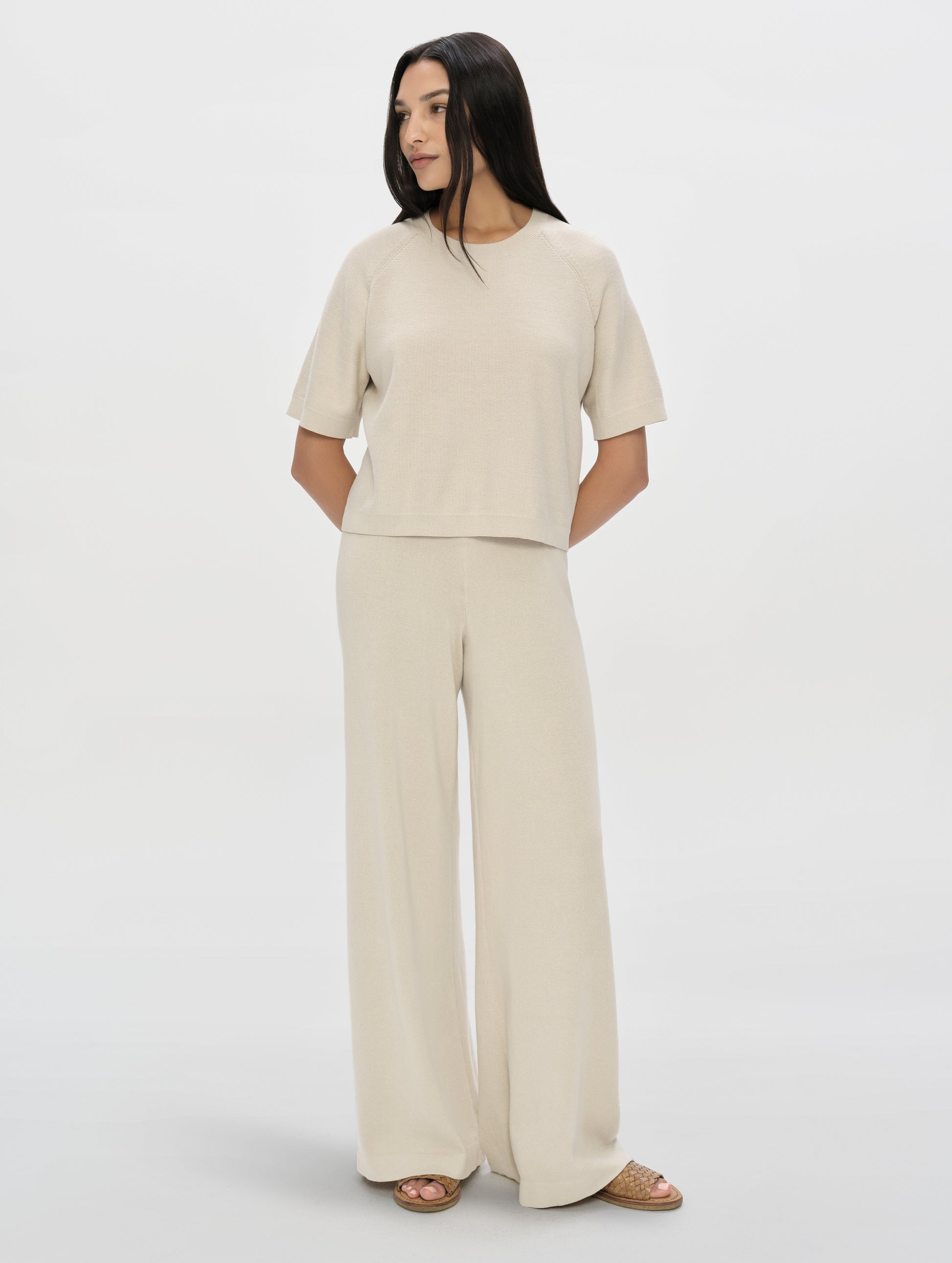 Front, full-body view of woman wearing the Eliana Sweater Tee in Bone from AETHER Apparel.