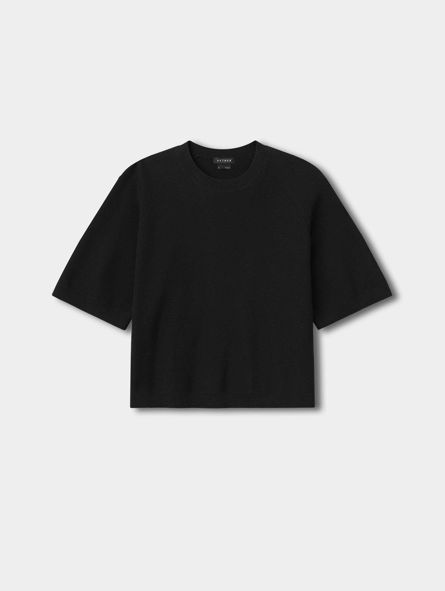 Flat lay view of the Eliana Sweater Tee in Onyx Black from AETHER.