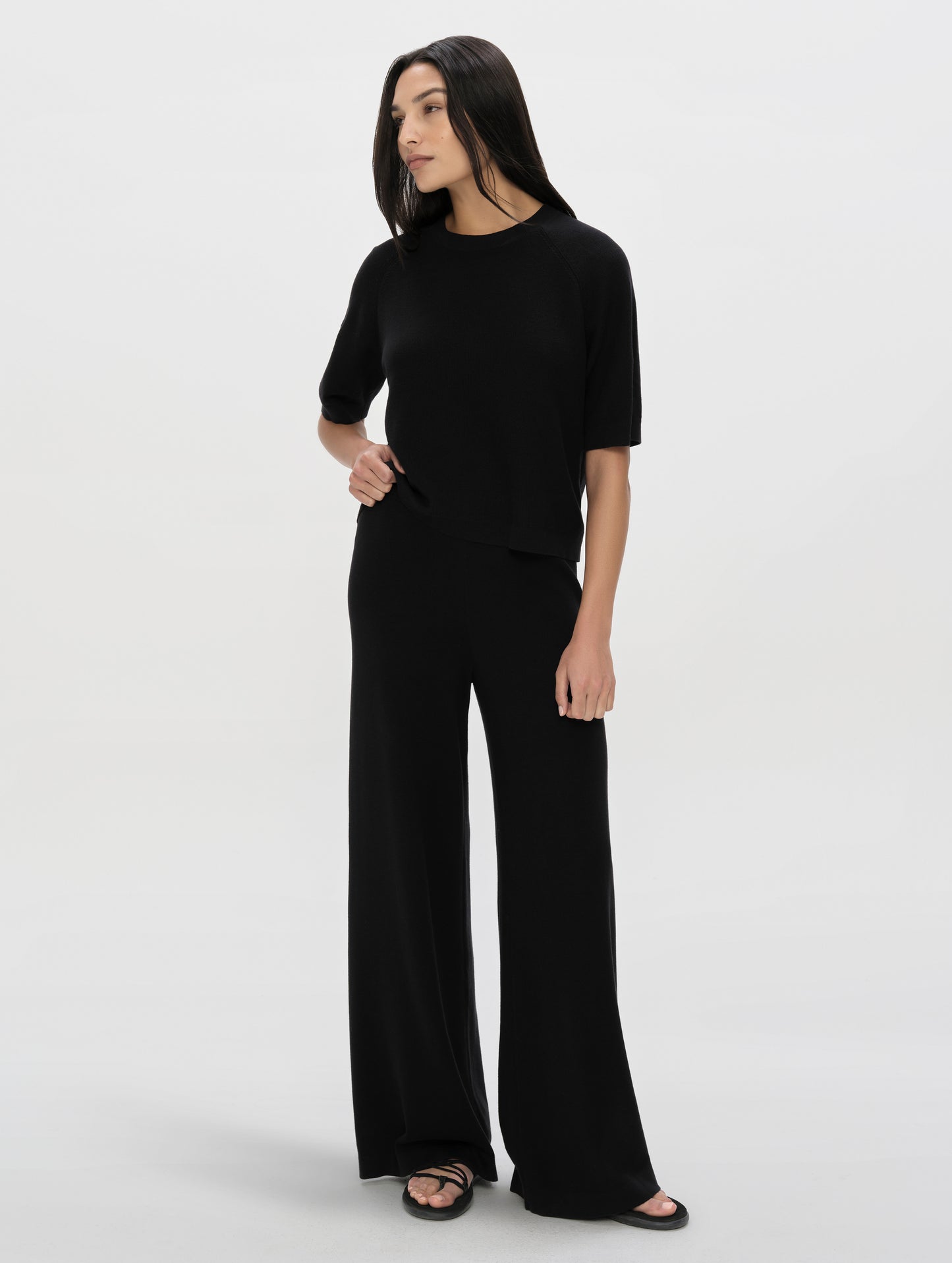 Front, full-body view of woman wearing the Eliana Sweater Tee in Onyx Black from AETHER Apparel.