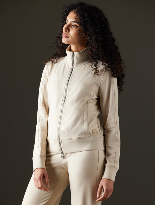 Woman wearing beige jacket from AETHER Apparel