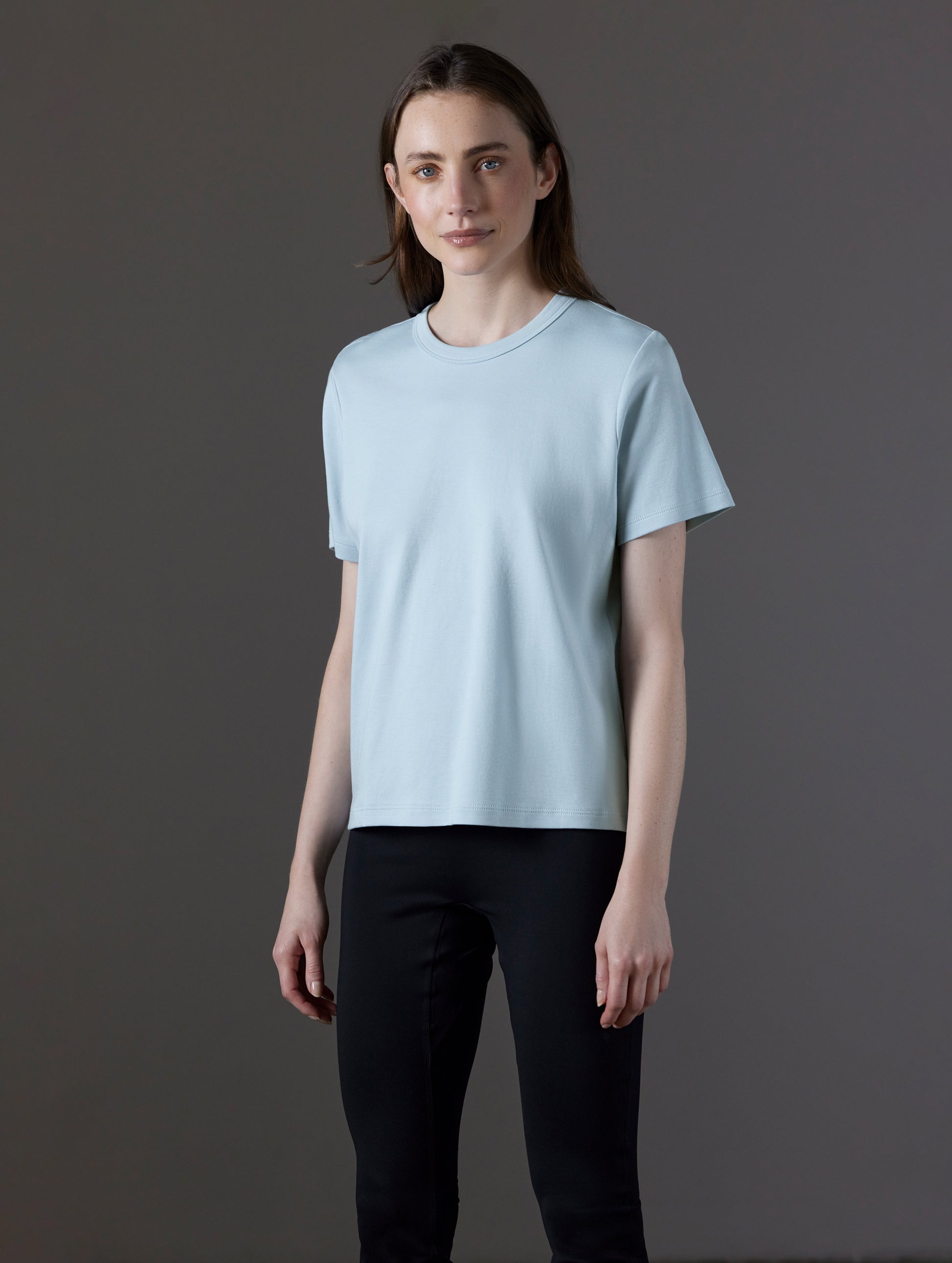 Front angled view of woman wearing Emery Pima Tee in Flight Blue from AETHER Apparel.