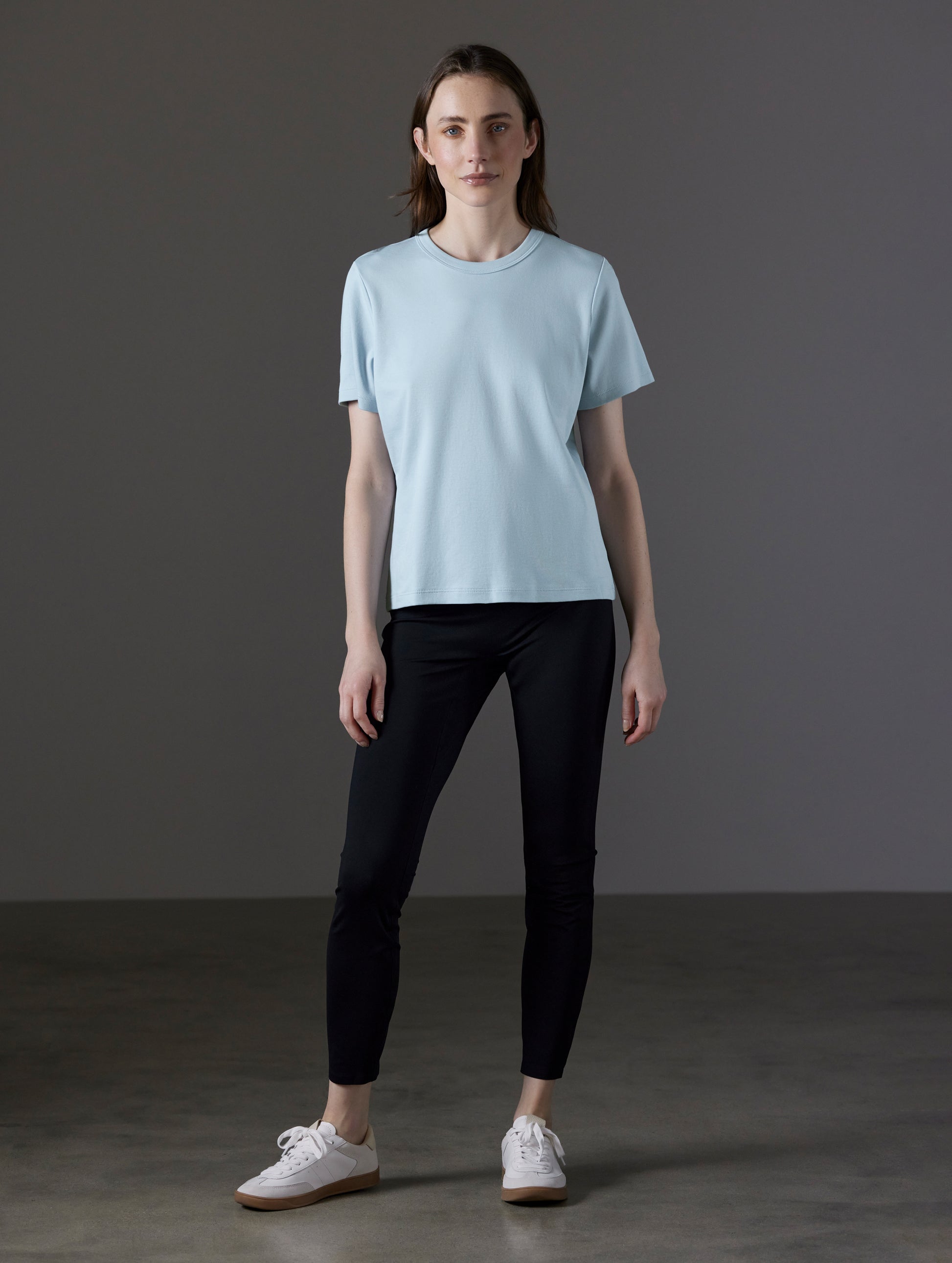 Front full-body view of woman wearing Emery Pima Tee in Flight Blue from AETHER Apparel.