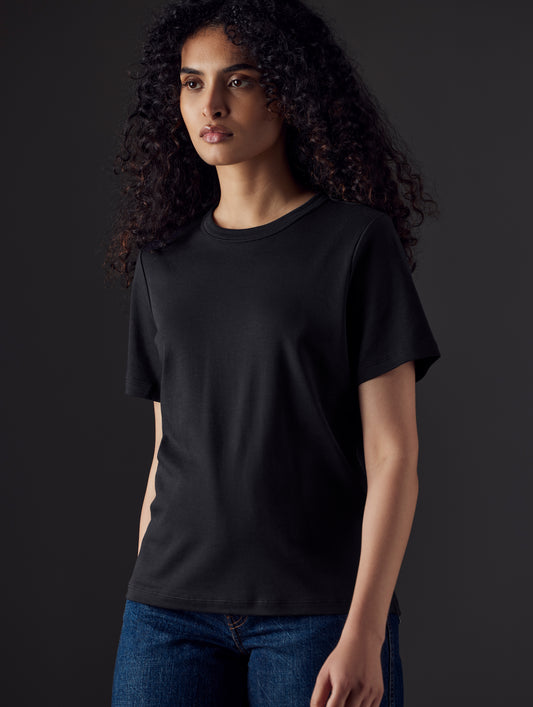 Woman wearing black organic tee from AETHER Apparel