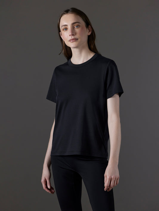 Front angled view of woman wearing Emery Pima Tee in Onyx Black from AETHER Apparel.