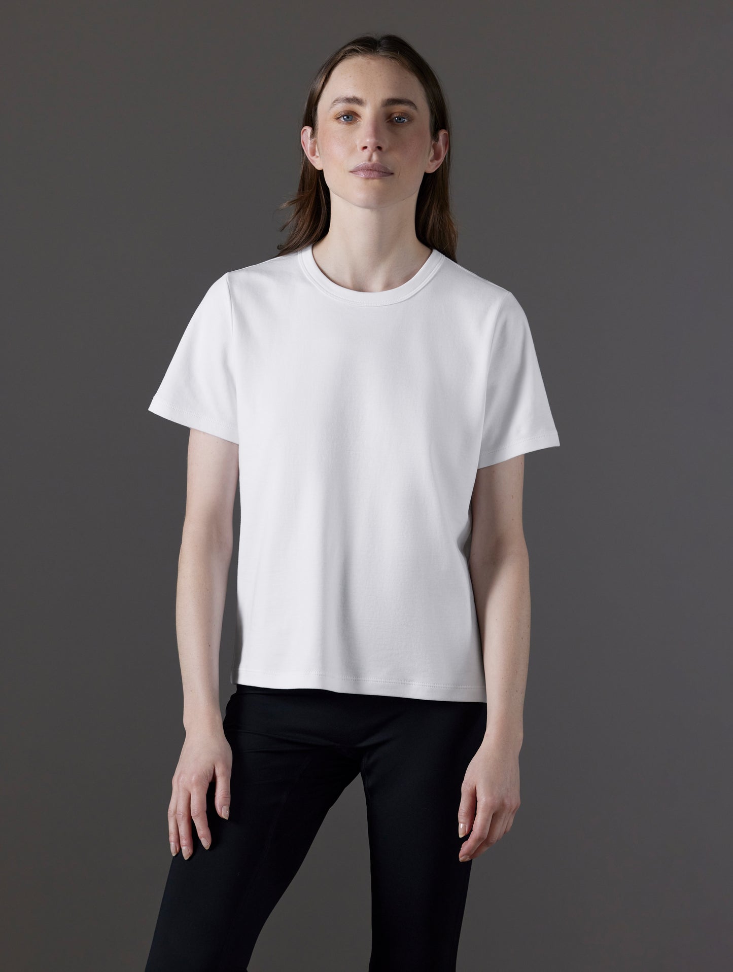 Front view of woman wearing Emery Pima Tee in White from AETHER Apparel.