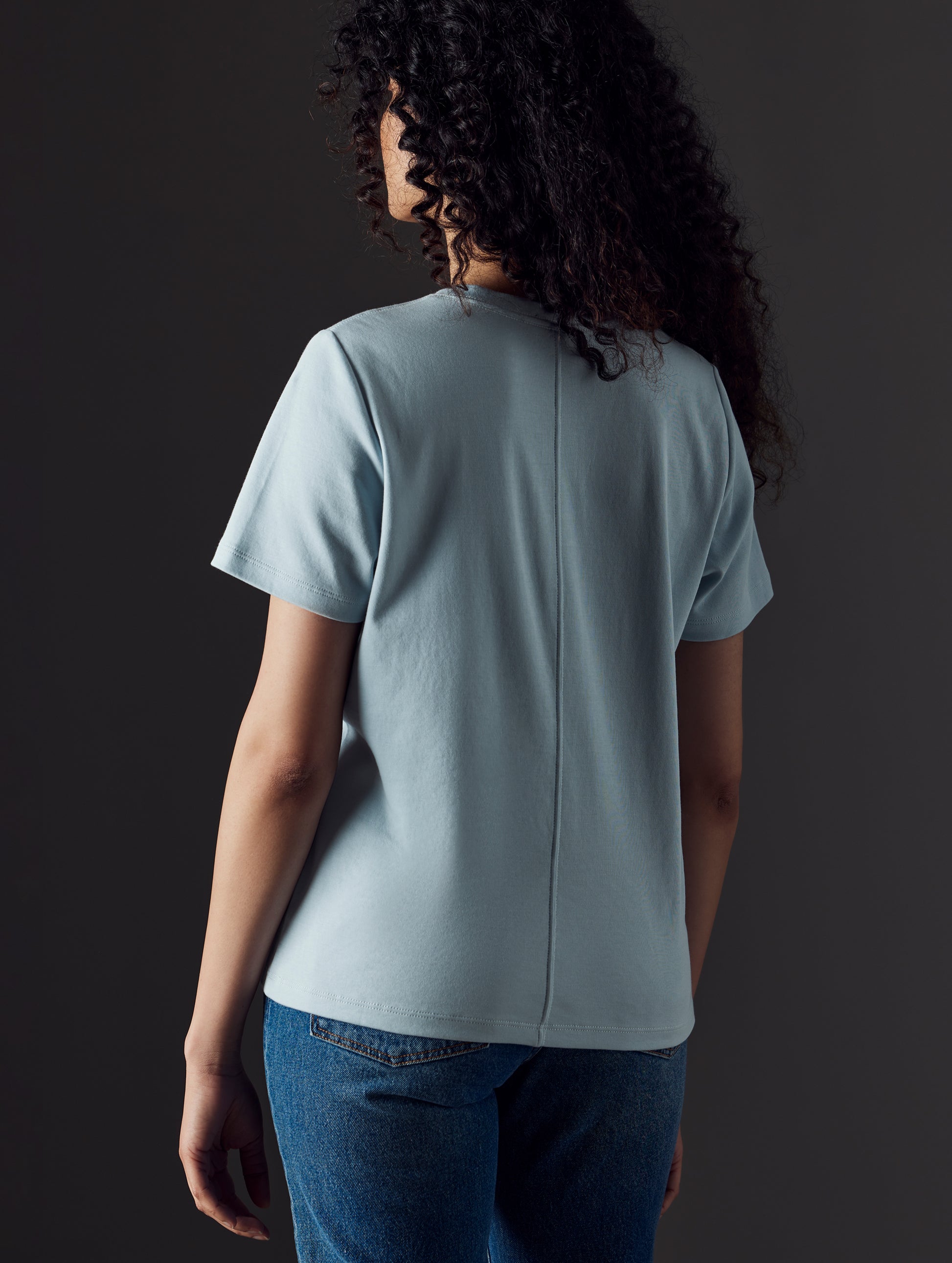 Woman wearing blue organic cotton v neck from AETHER Apparel