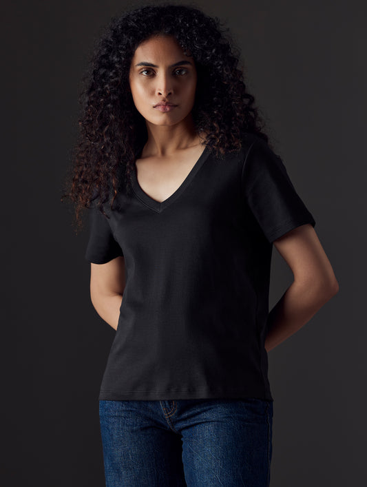Woman wearing black organic cotton v neck from AETHER Apparel
