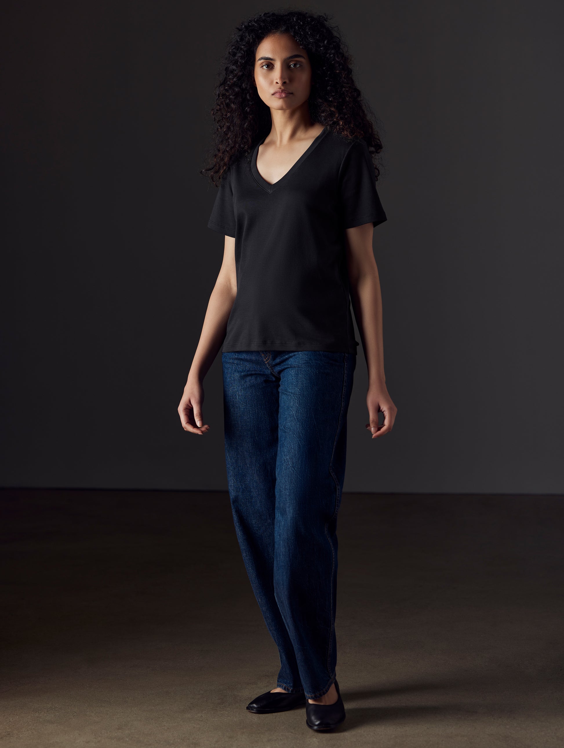 Woman wearing black organic cotton v neck from AETHER Apparel