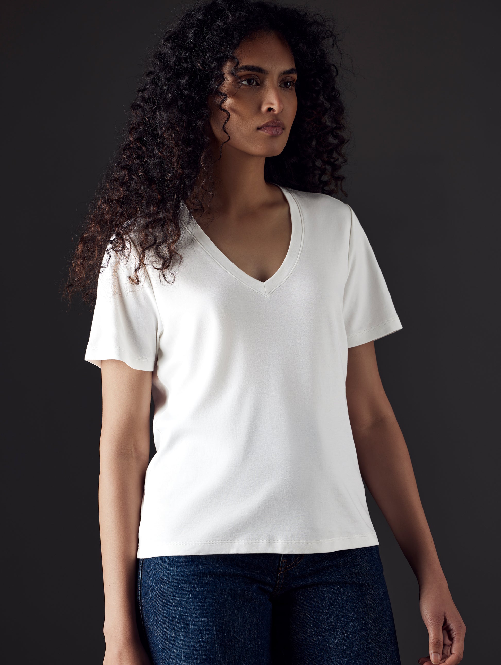 Woman wearing white organic cotton v neck from AETHER Apparel