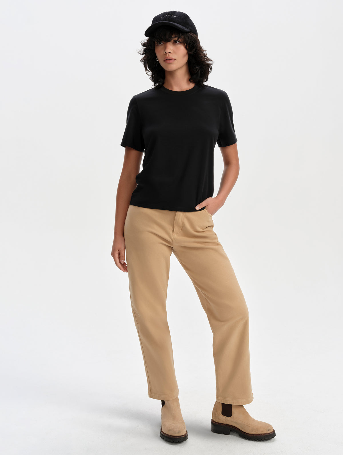 Front full-body view of woman wearing the Hana Short-Sleeve Tee Shirt in Onyx Black from AETHER Apparel.