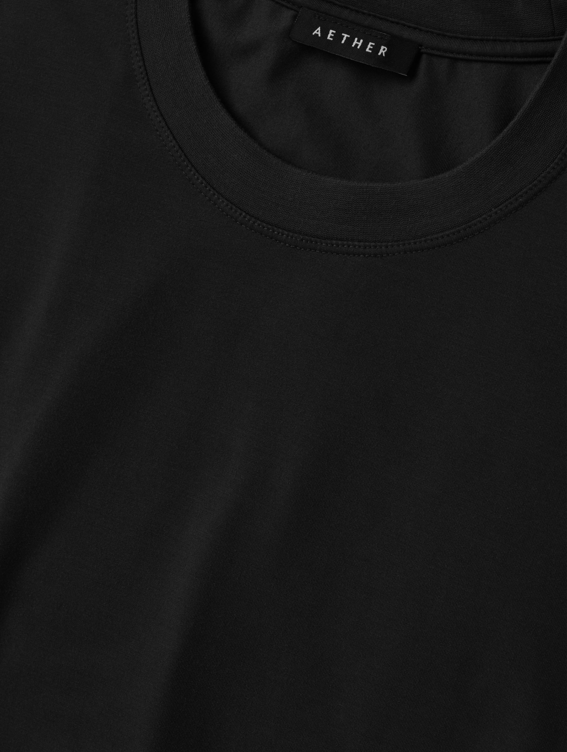 Closeup detailed view of the self neck band on the Hana Short-Sleeve Tee Shirt in Onyx Black from AETHER Apparel.