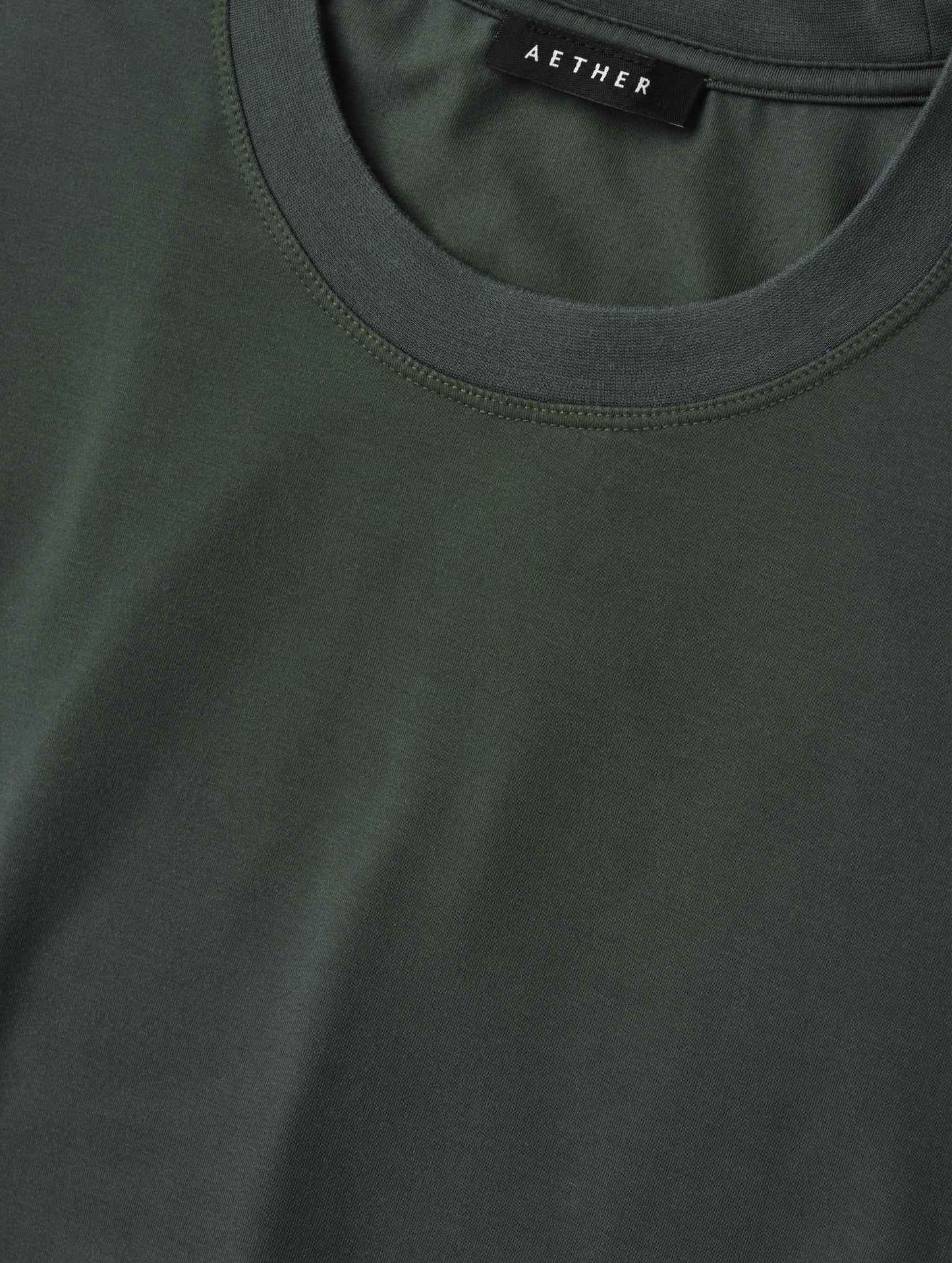 Closeup detailed view of the self neck band on the Hana Short-Sleeve Tee Shirt in Saville Green from AETHER Apparel.