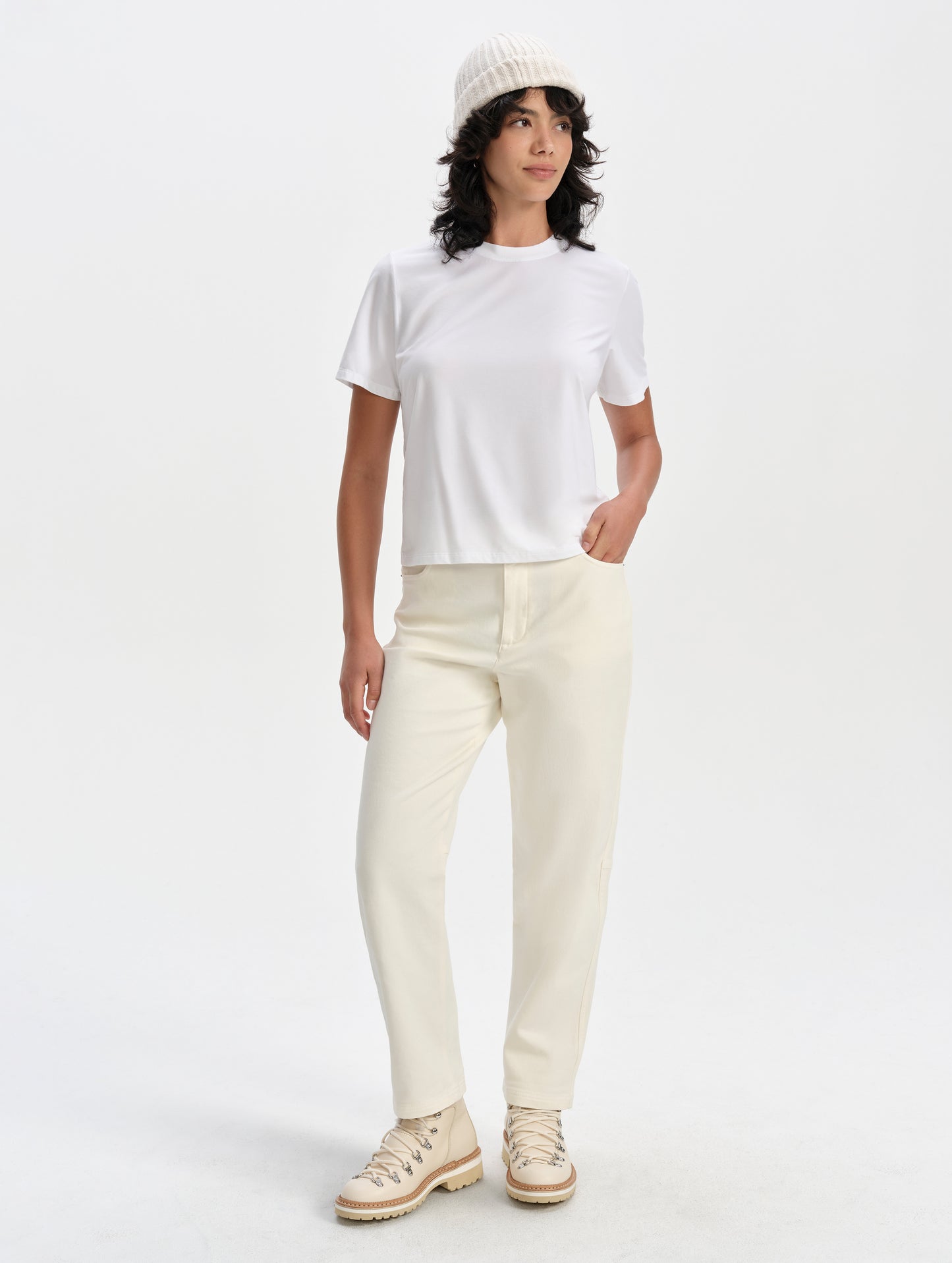 Front full-body view of woman wearing the Hana Short-Sleeve Tee Shirt in White from AETHER Apparel.
