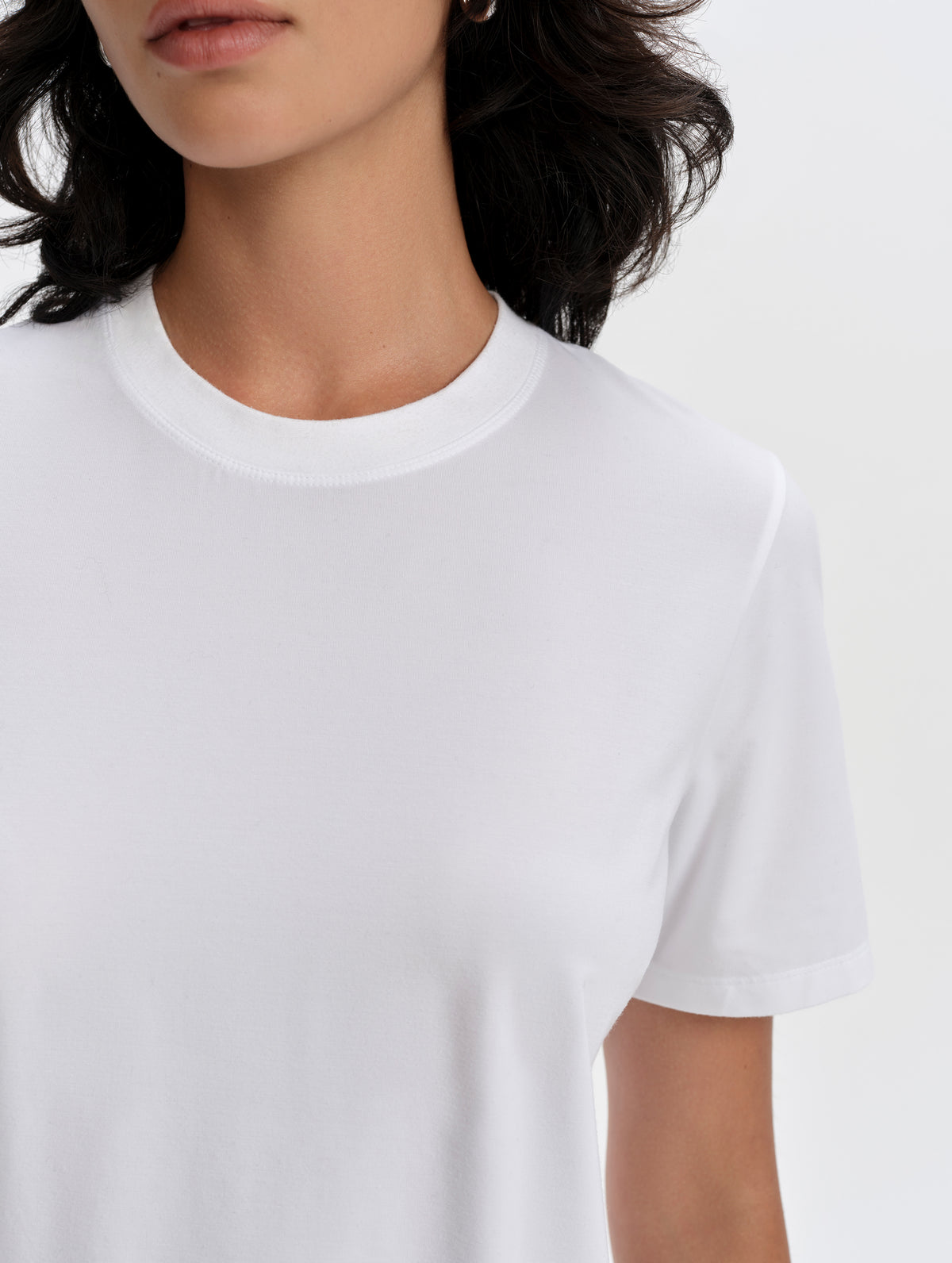Closeup detailed view of he short sleeve cuffs and collar on the Hana Short-Sleeve Tee Shirt in White from AETHER Apparel.