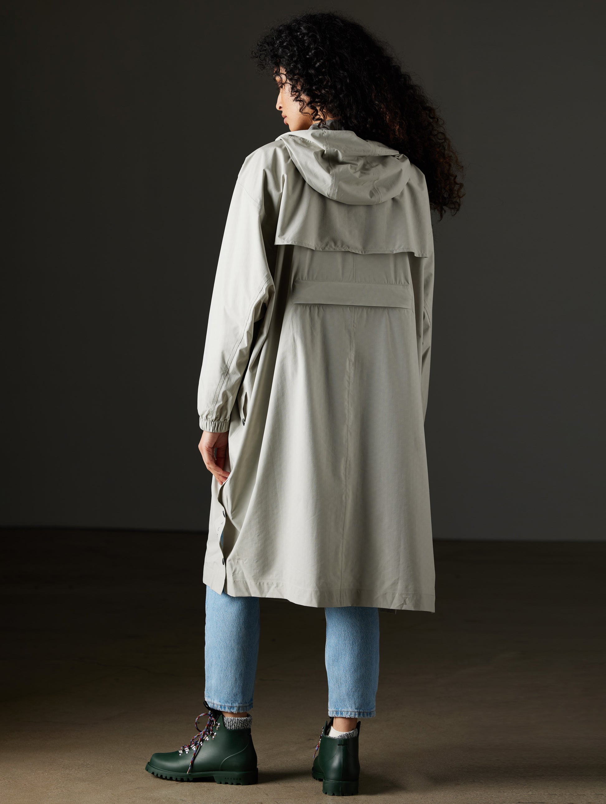 Back view of woman wearing grey poncho from AETHER Apparel