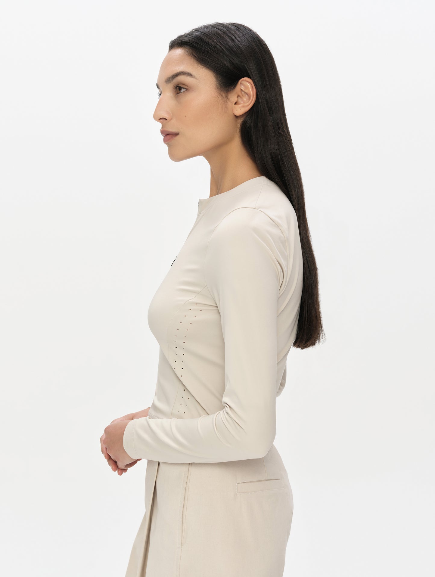 Side profile, upper-body view of woman wearing the Kora Sunproof Shirt in Bone from AETHER Apparel.