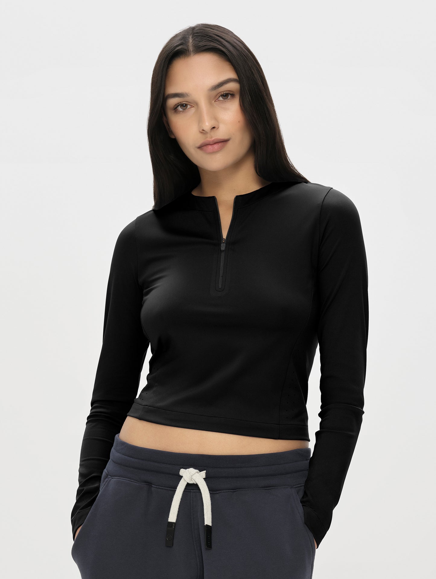 Front, upper-body view of woman wearing the Kora Sunproof Shirt in Onyx Black from AETHER Apparel.