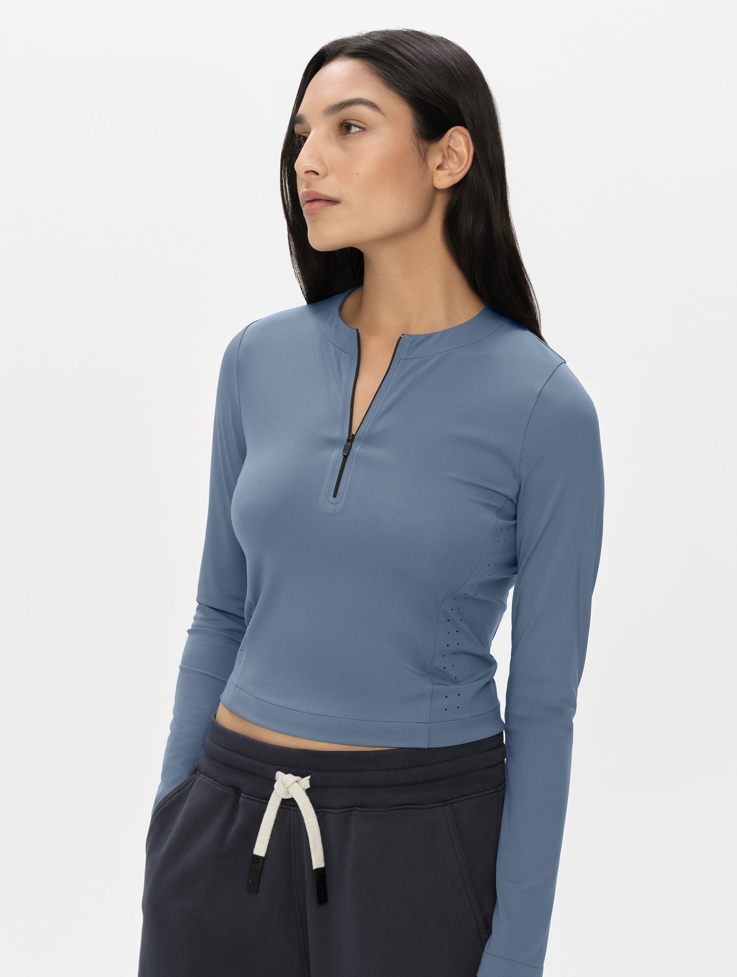 Front, upper-body view of woman wearing the Kora Sunproof Shirt in Portal Blue from AETHER Apparel.