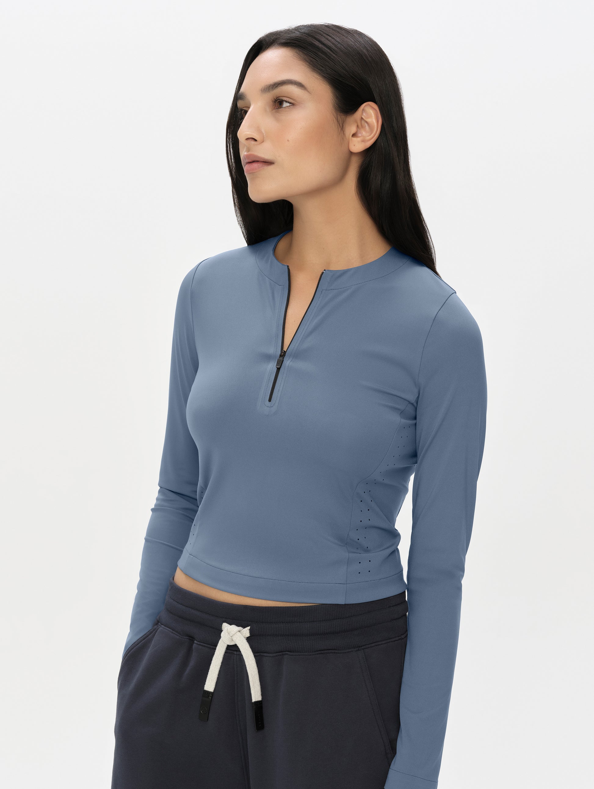 Front, upper-body view of woman wearing the Kora Sunproof Shirt in Portal Blue from AETHER Apparel.