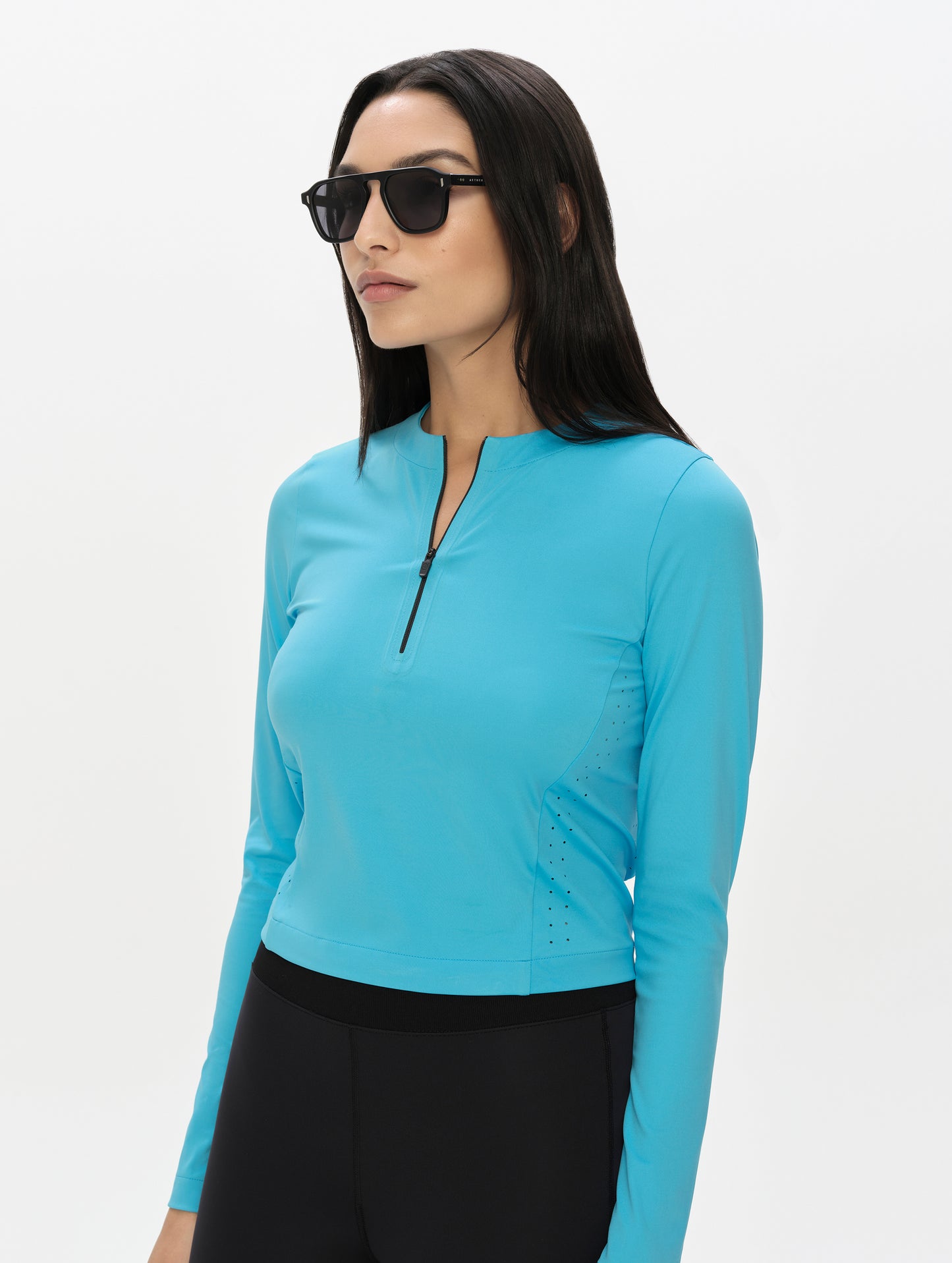 Front, 3/4, upper-body view of woman wearing the Kora Sunproof Shirt in Sky Blue from AETHER Apparel.