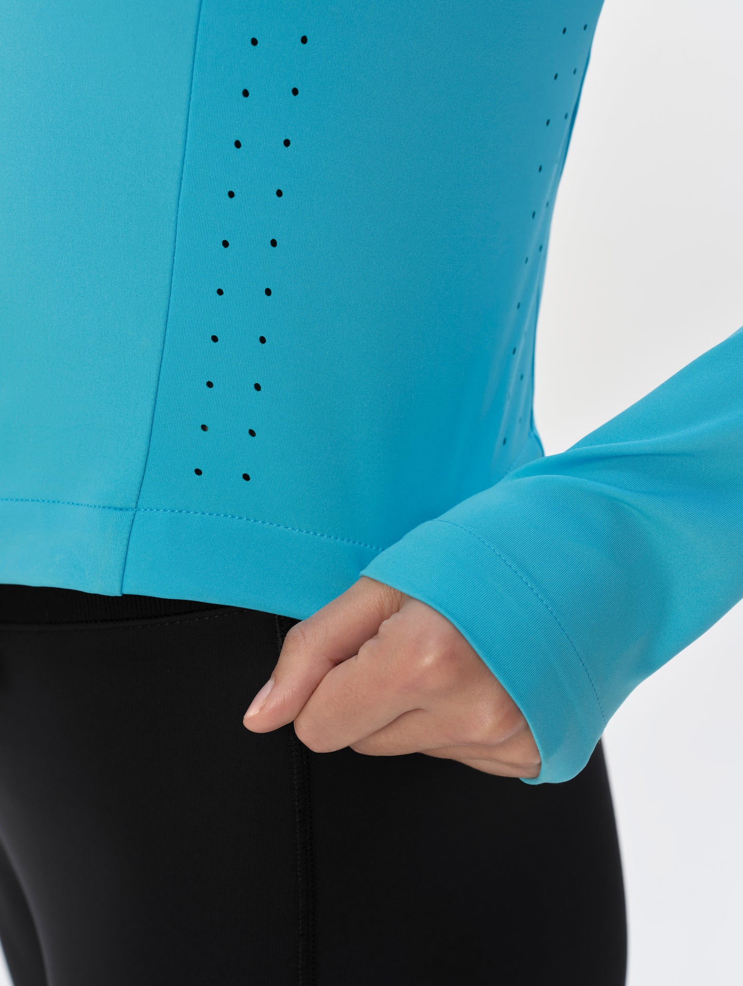 Closeup detailed view of the cuffs and laser-cut side panel ventilation on the Kora Sunproof Shirt in Sky Blue from AETHER Apparel.